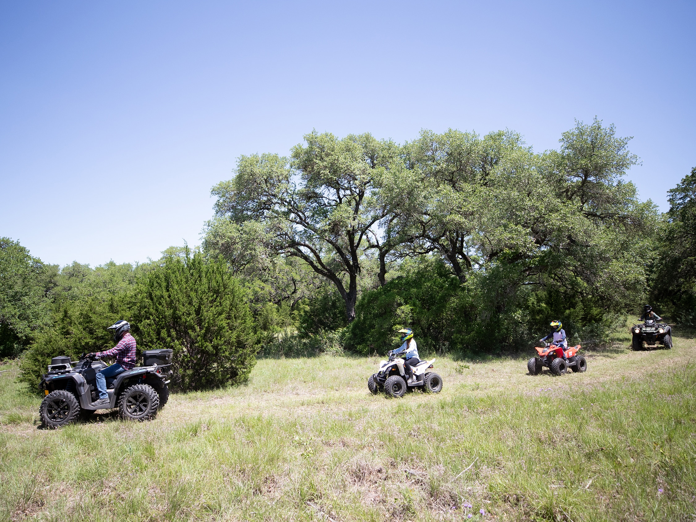 Family riding with their Can-Am Off-Road vehicles