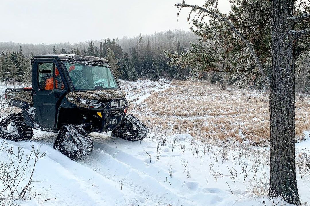 A Can-Am Defender Limited side-by-side with track system on snow