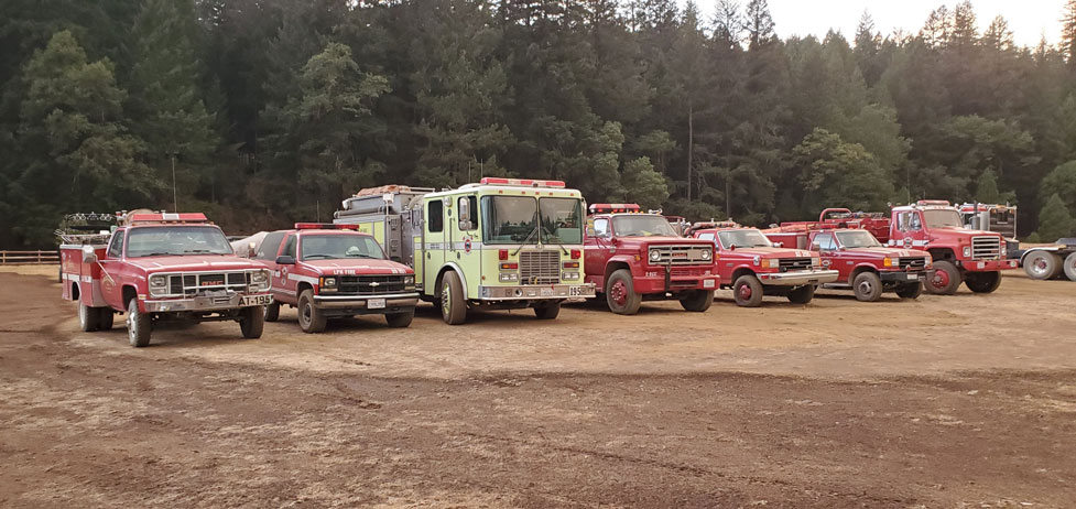 Many parked firefighter trucks