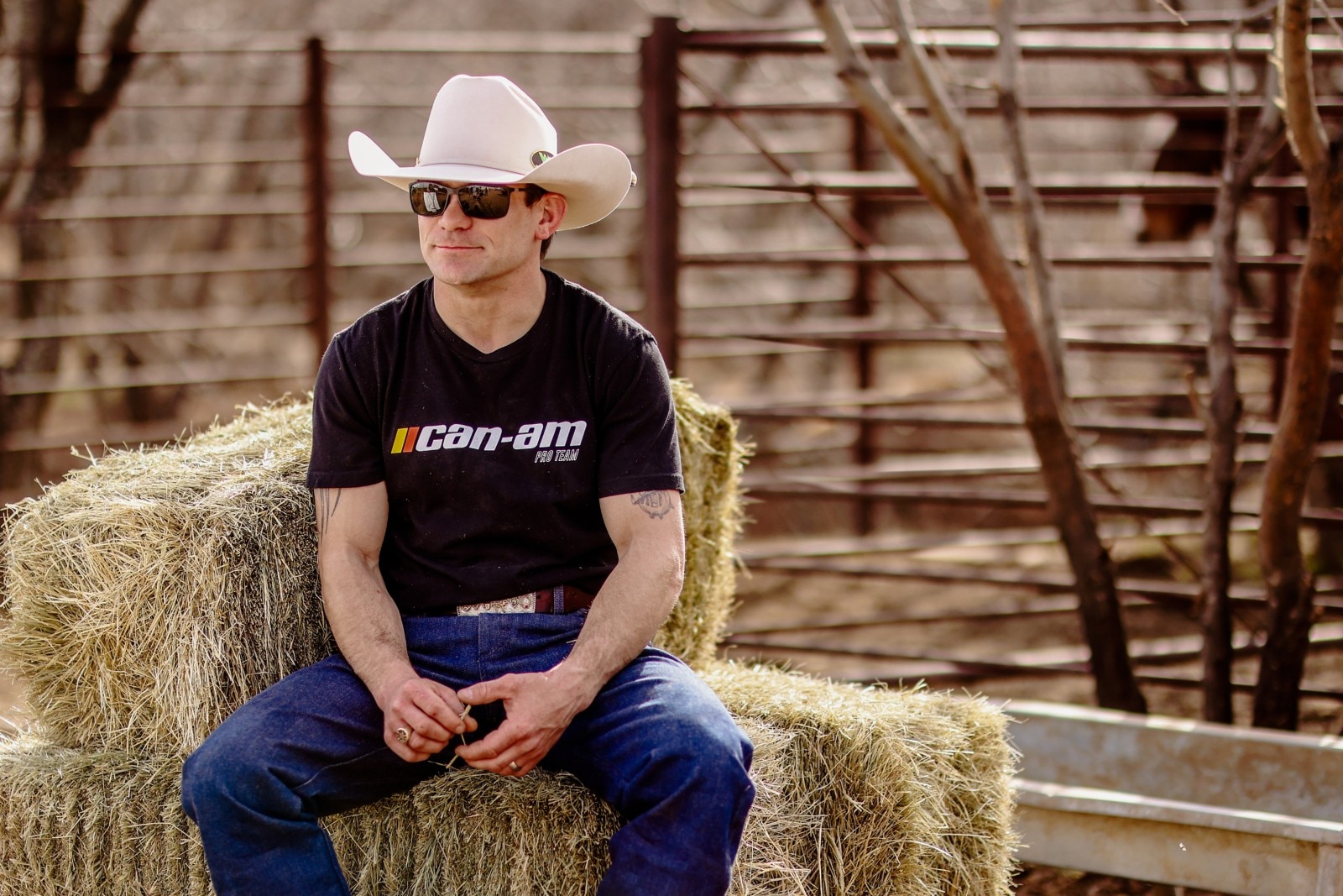 A cowboy sitting on blocks of hay