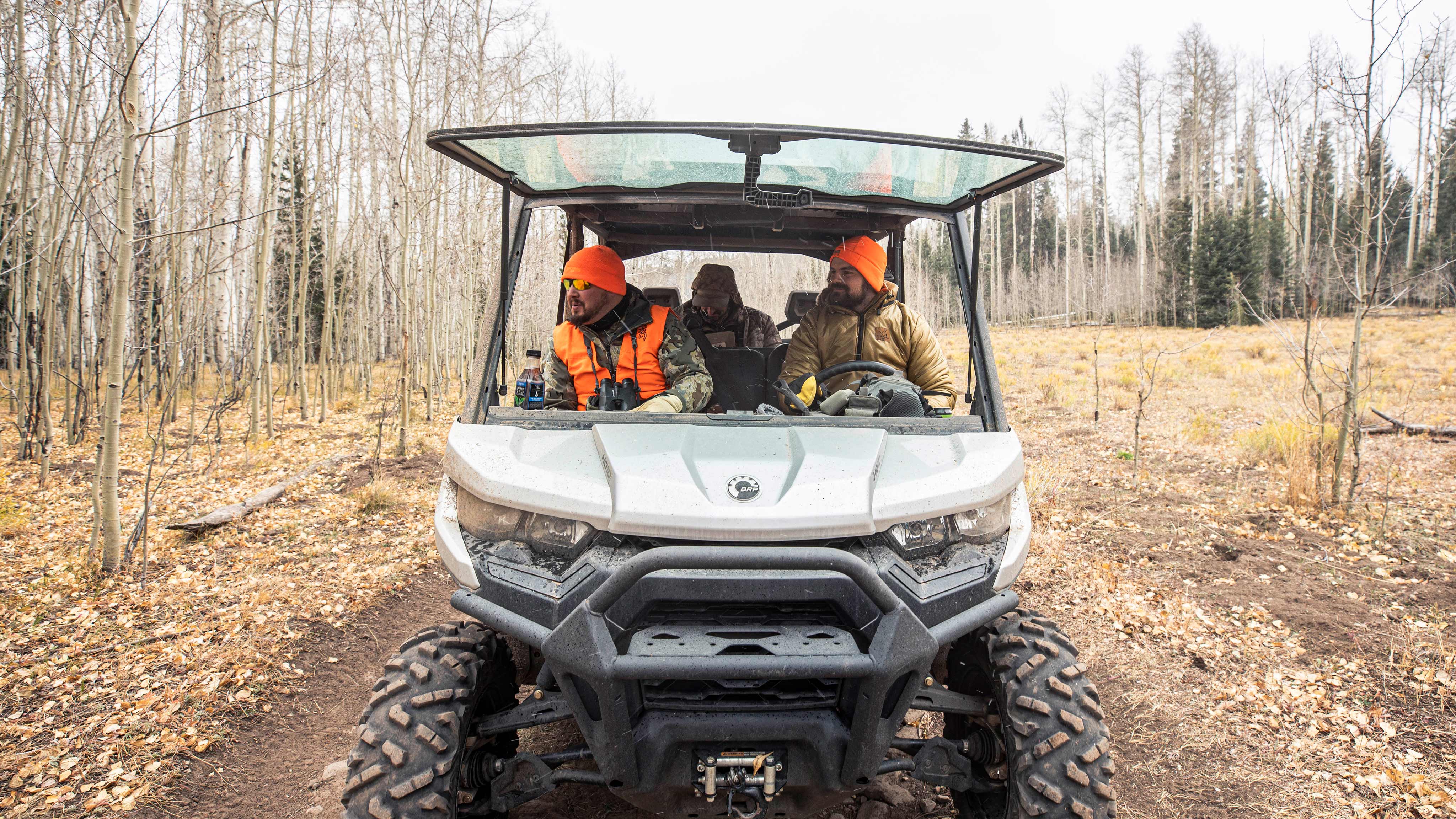Three men in Can-Am Defender
