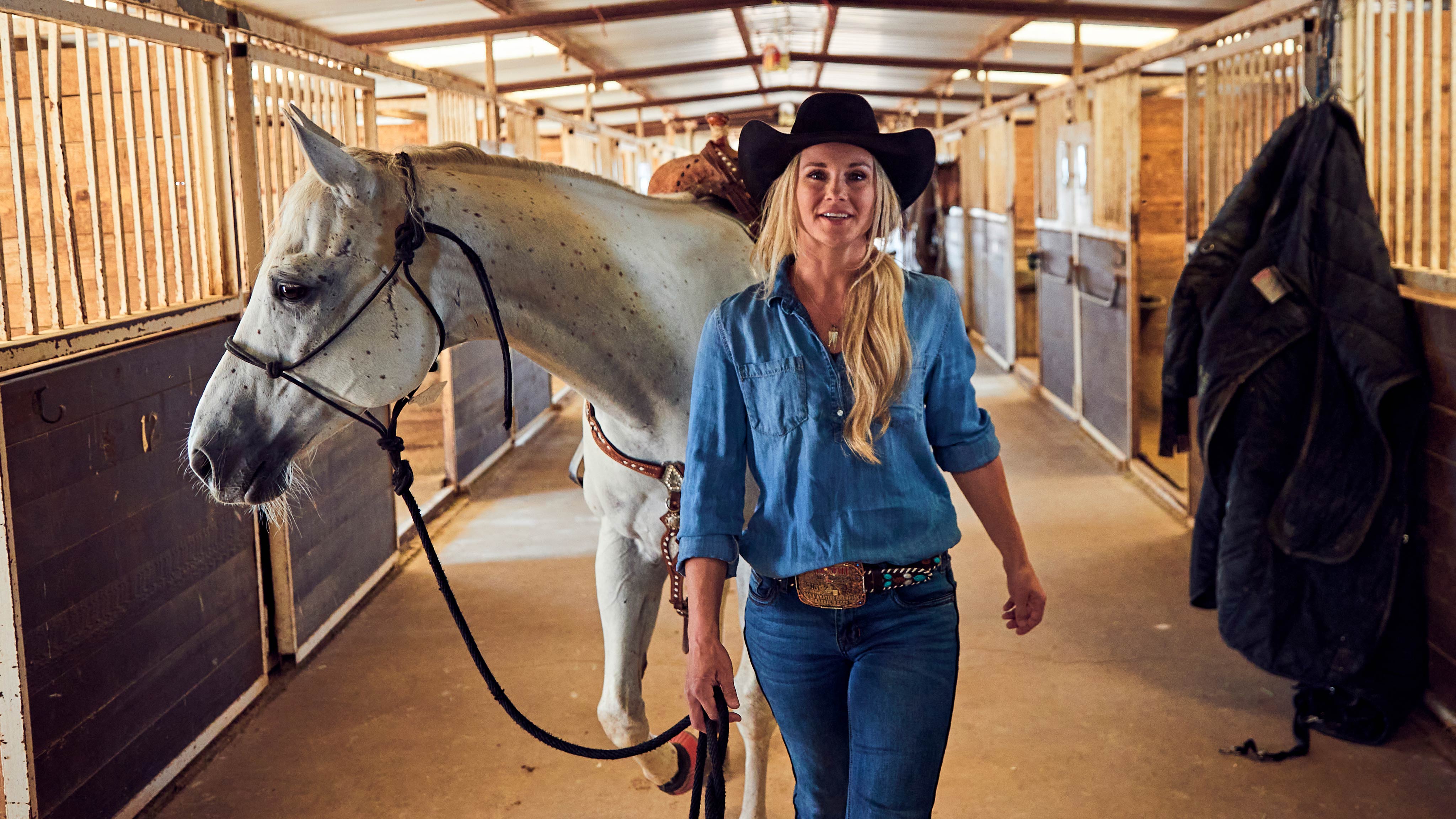 Kristy Lee Cook walking with a horse