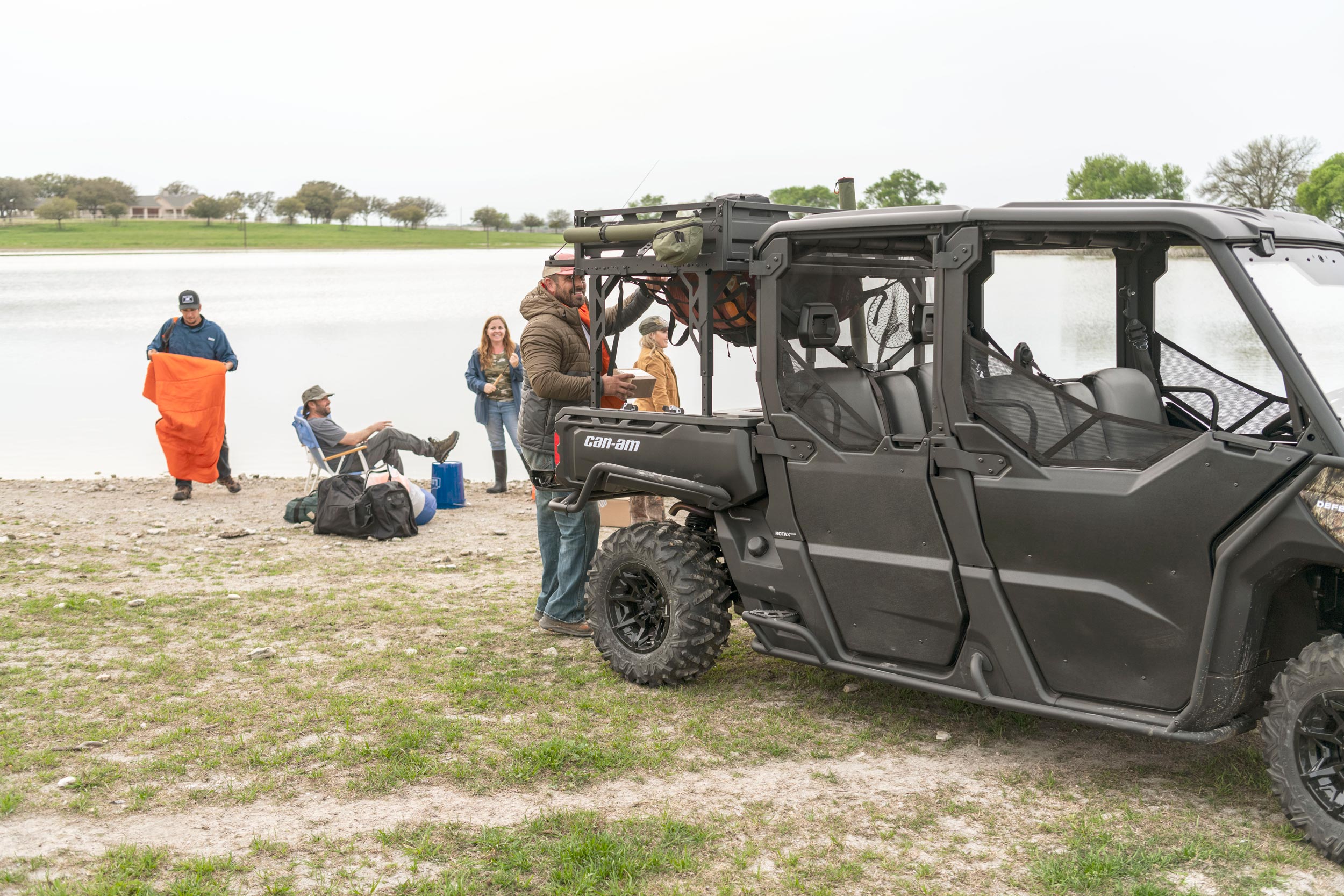 A group of people going fishing and a 6-seater Can-Am Defender MAX side-by-side