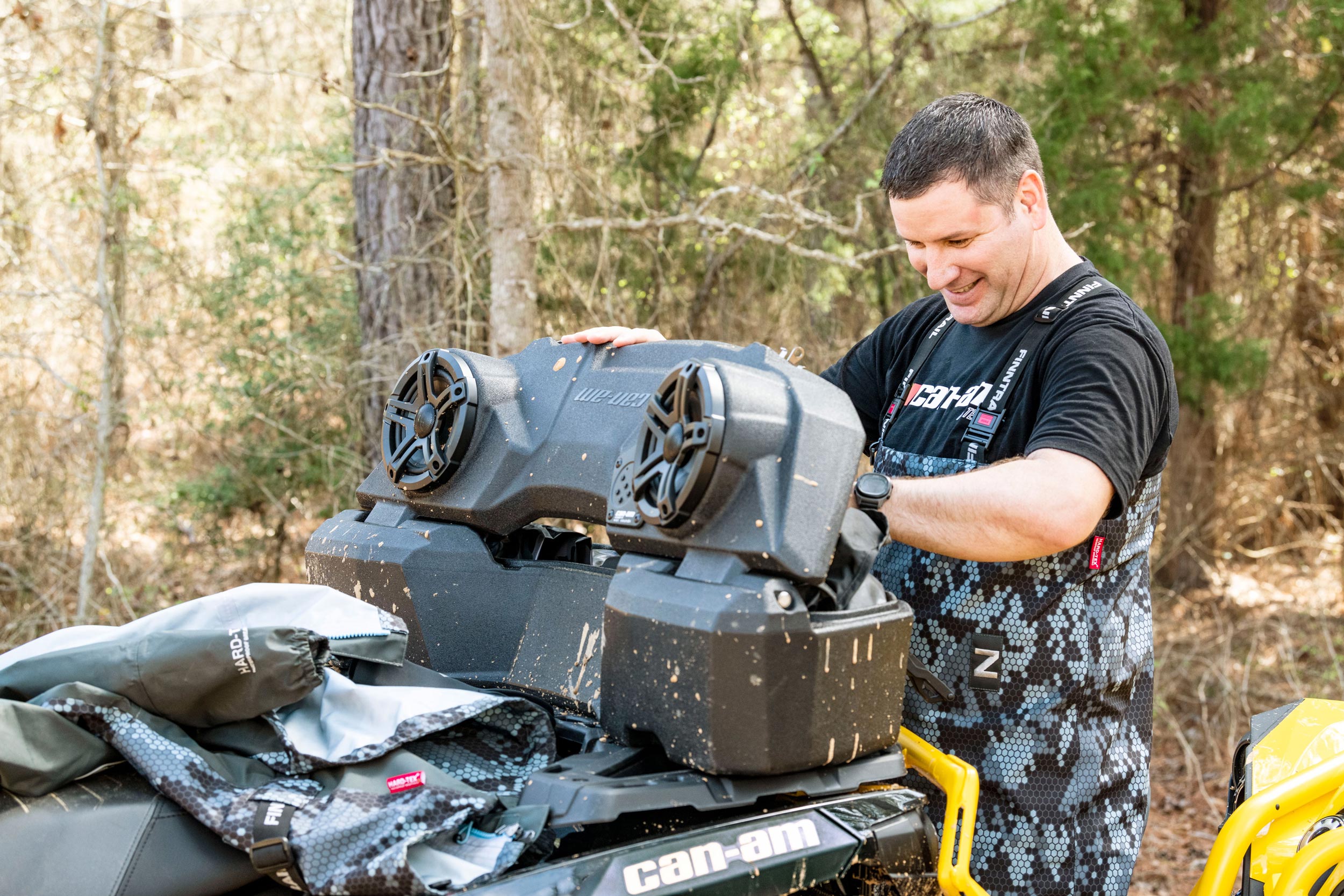 Man looking at a LinQ Audio Cargo Box on a Can-Am Off-Road ATV