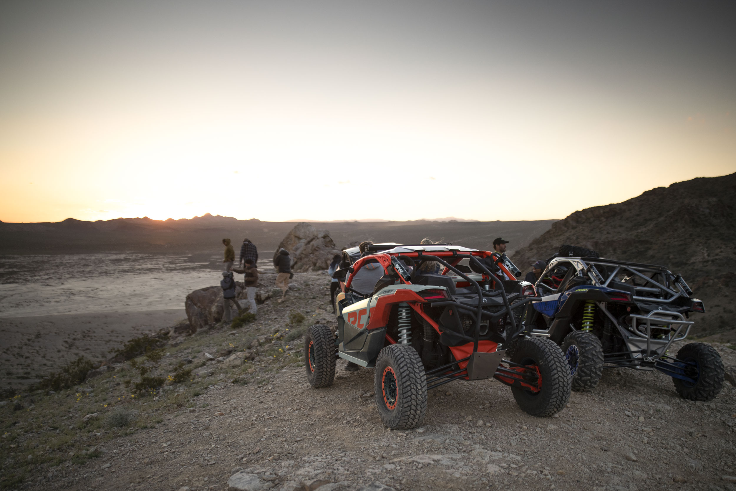 Rear view of two parked Can-Am Maverick X3 on a gravel path