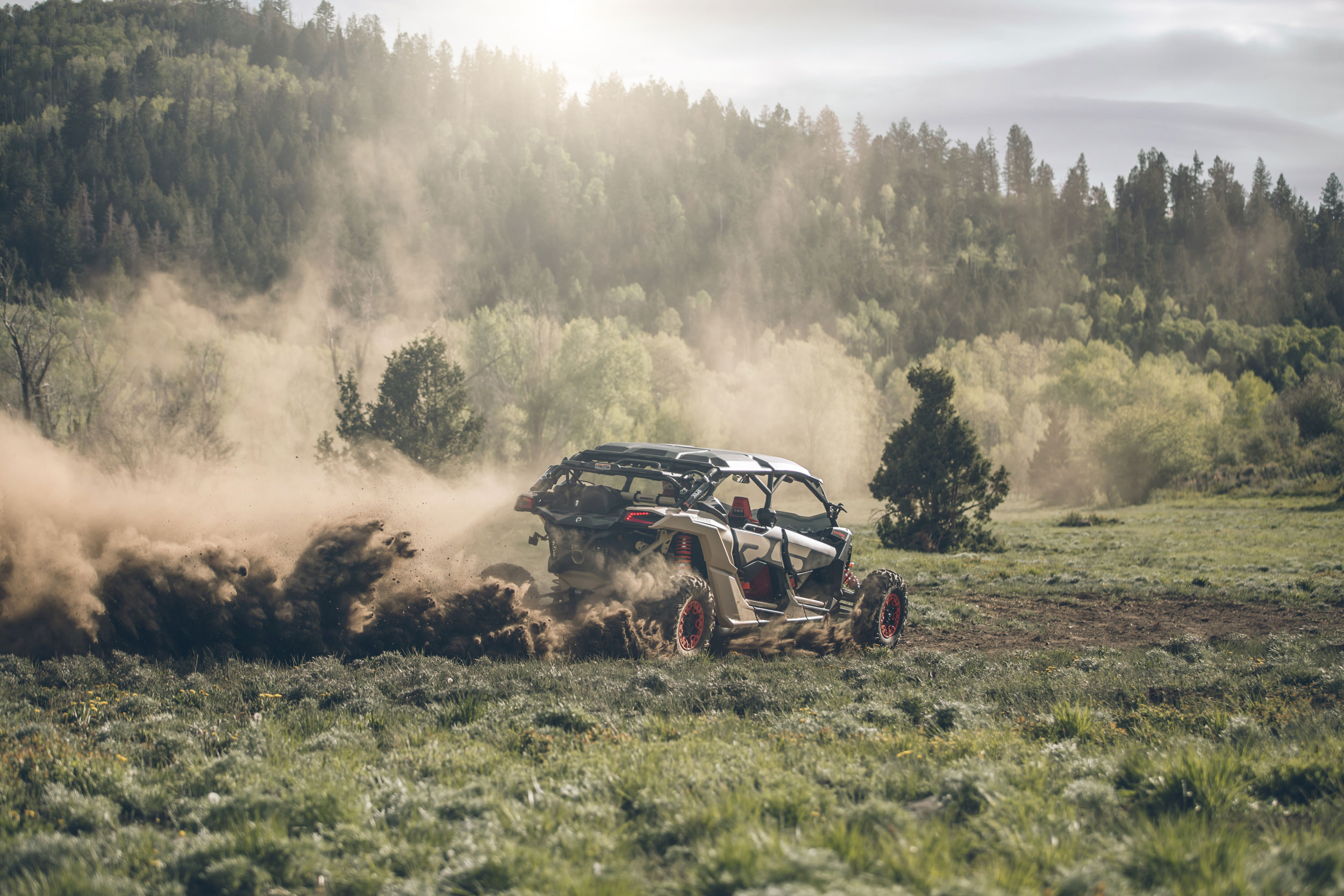 A Can-Am Maverick X3 X rs side-by-side drifting in a trail