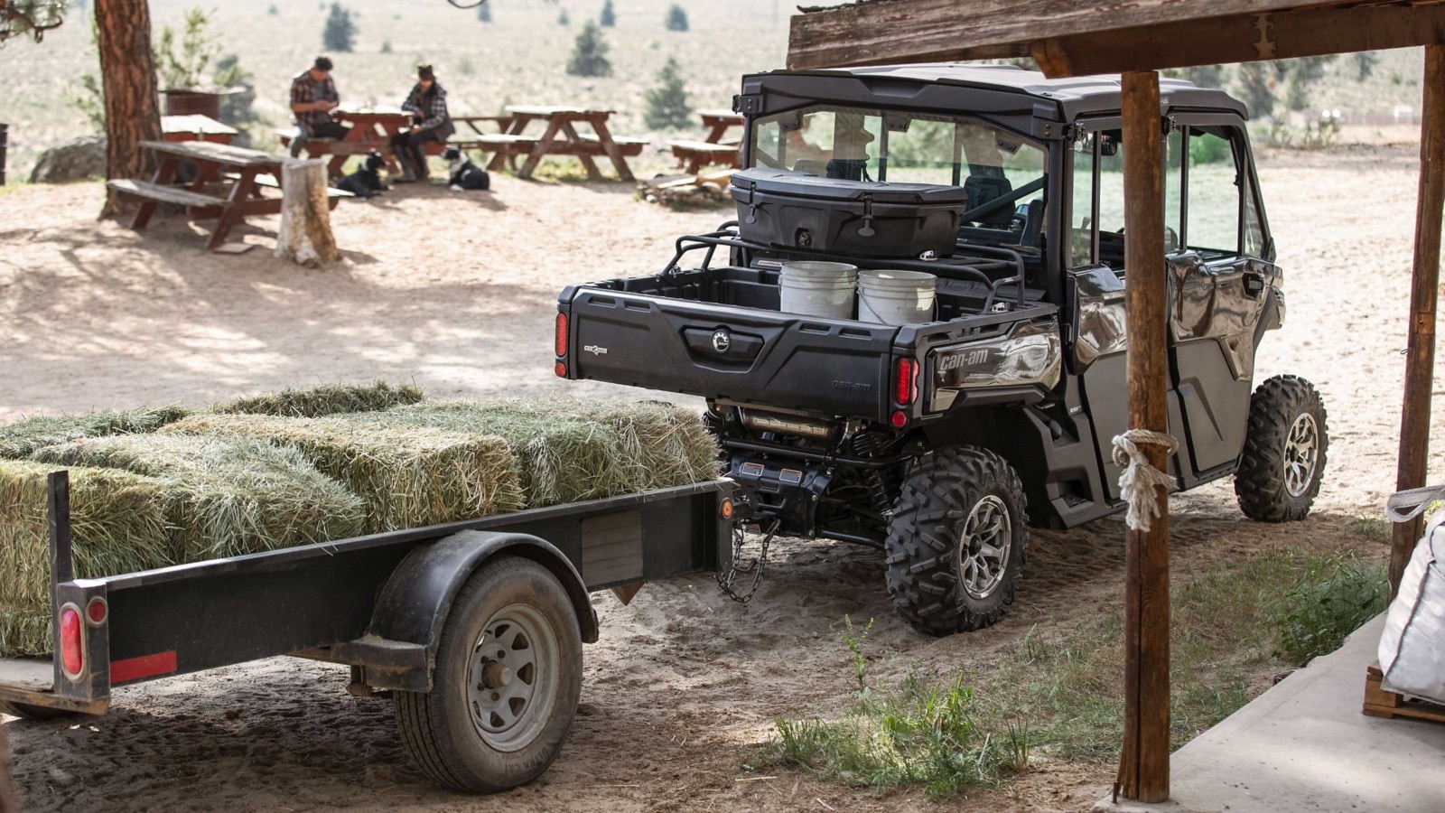 Defender Max Lone Star Cab loaded with work gear, hauling a trailer full of hay.
