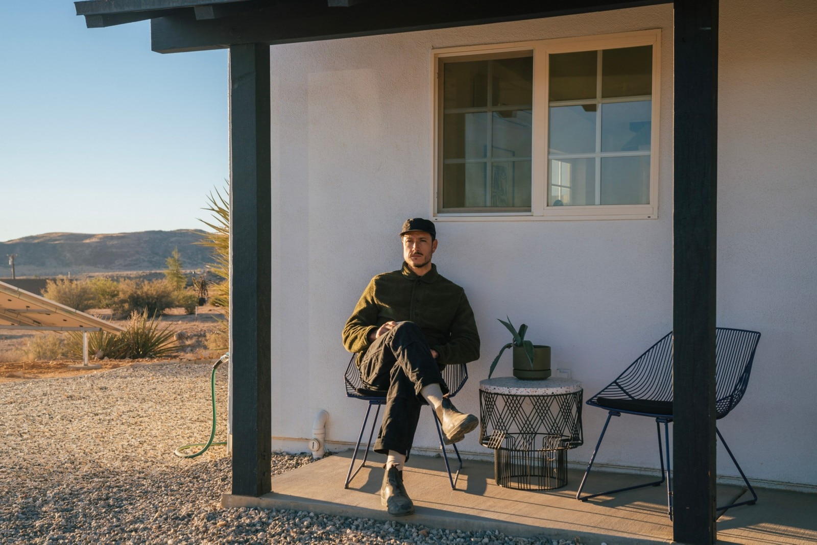 Carlos Naude sitting on the front porch of his Californian house early in the morning