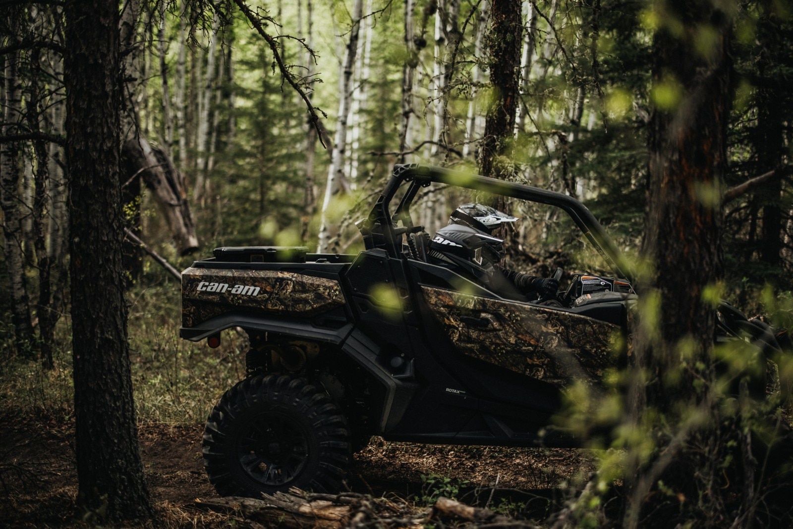 SxS side profile with two riders in the woods