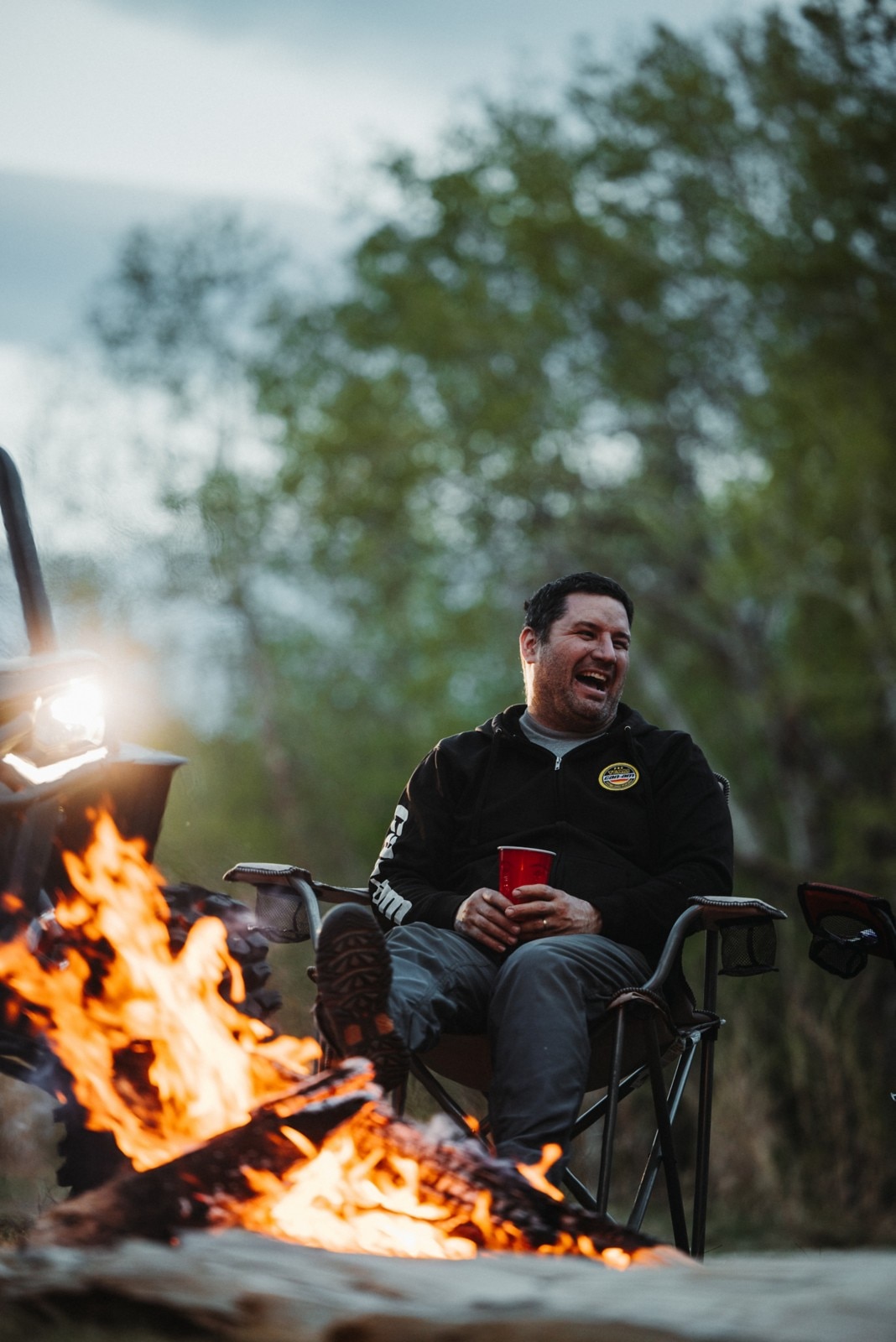 Guy grilling marshmallow by bonfire