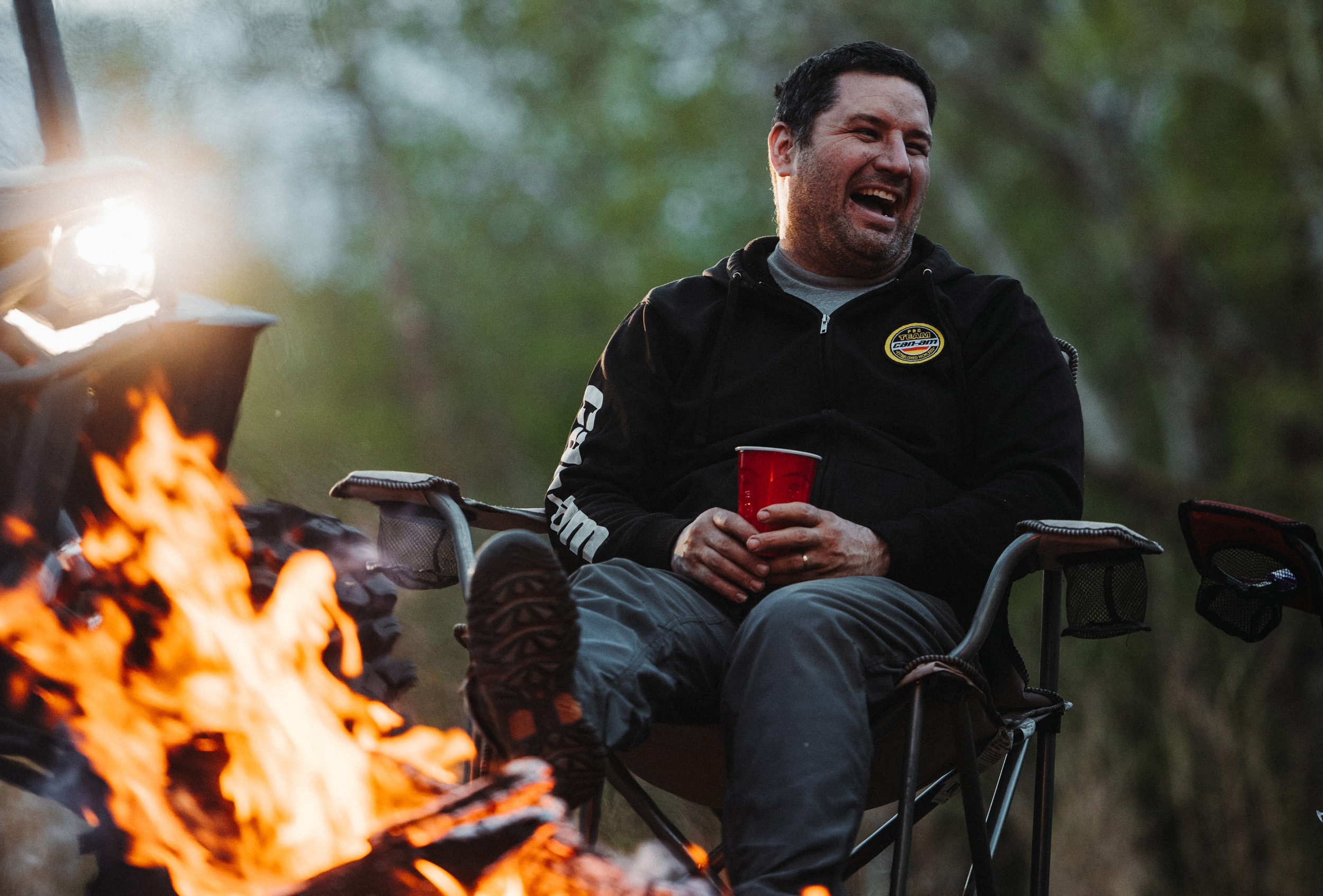 Off-Road enthusiast sitting by campfire