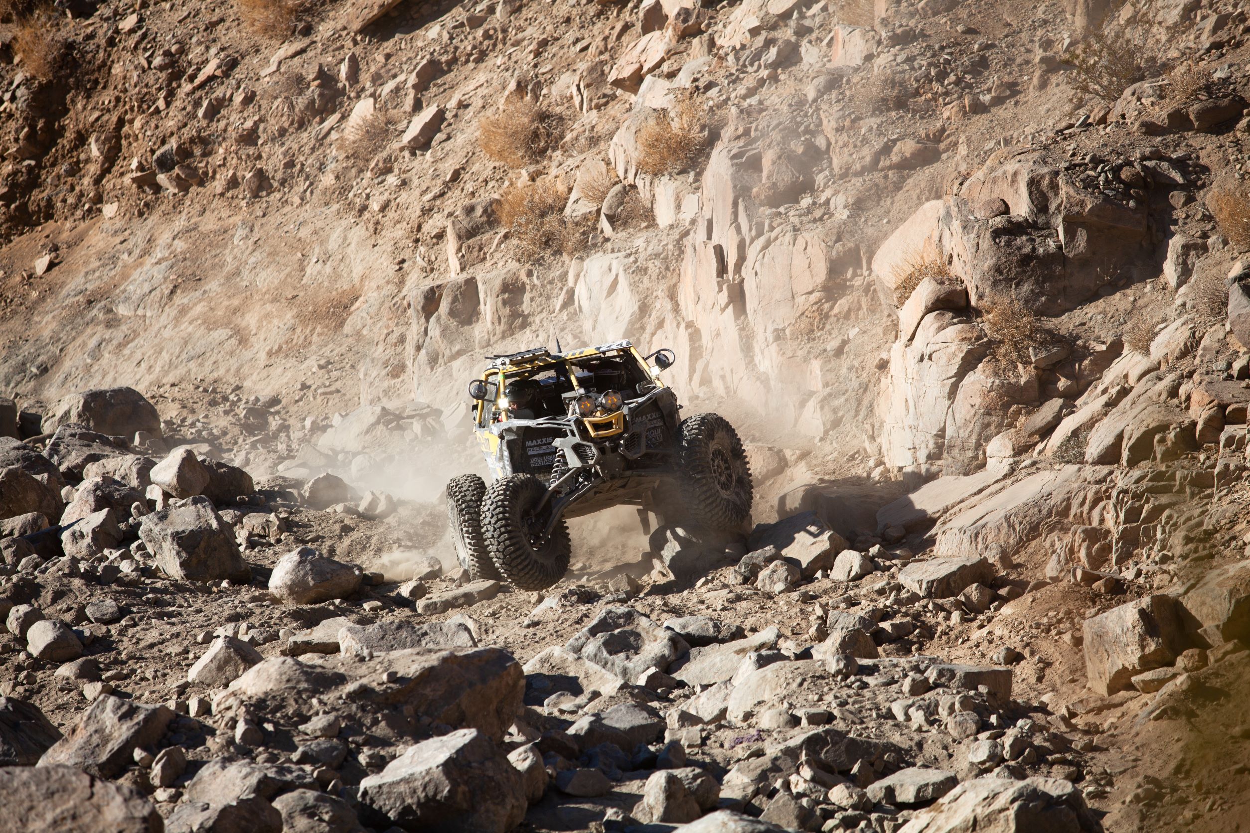 A Maverick X3 driving in rocky conditions during the Kind of the Hammers race