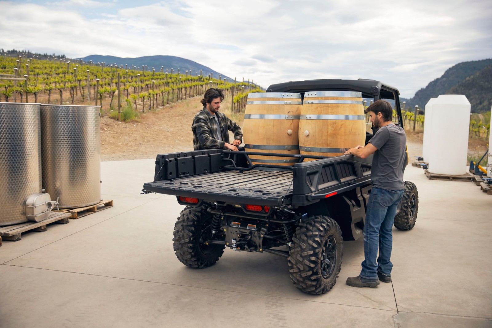 2 men working in a vineyard with their Can-Am vehicle