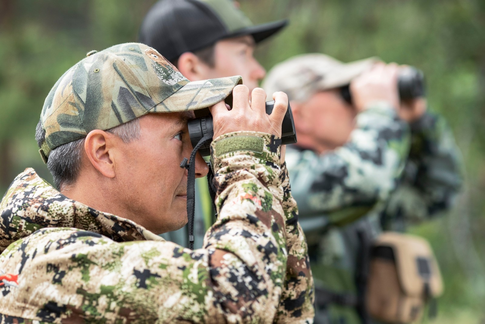 Hunters looking through their binoculars