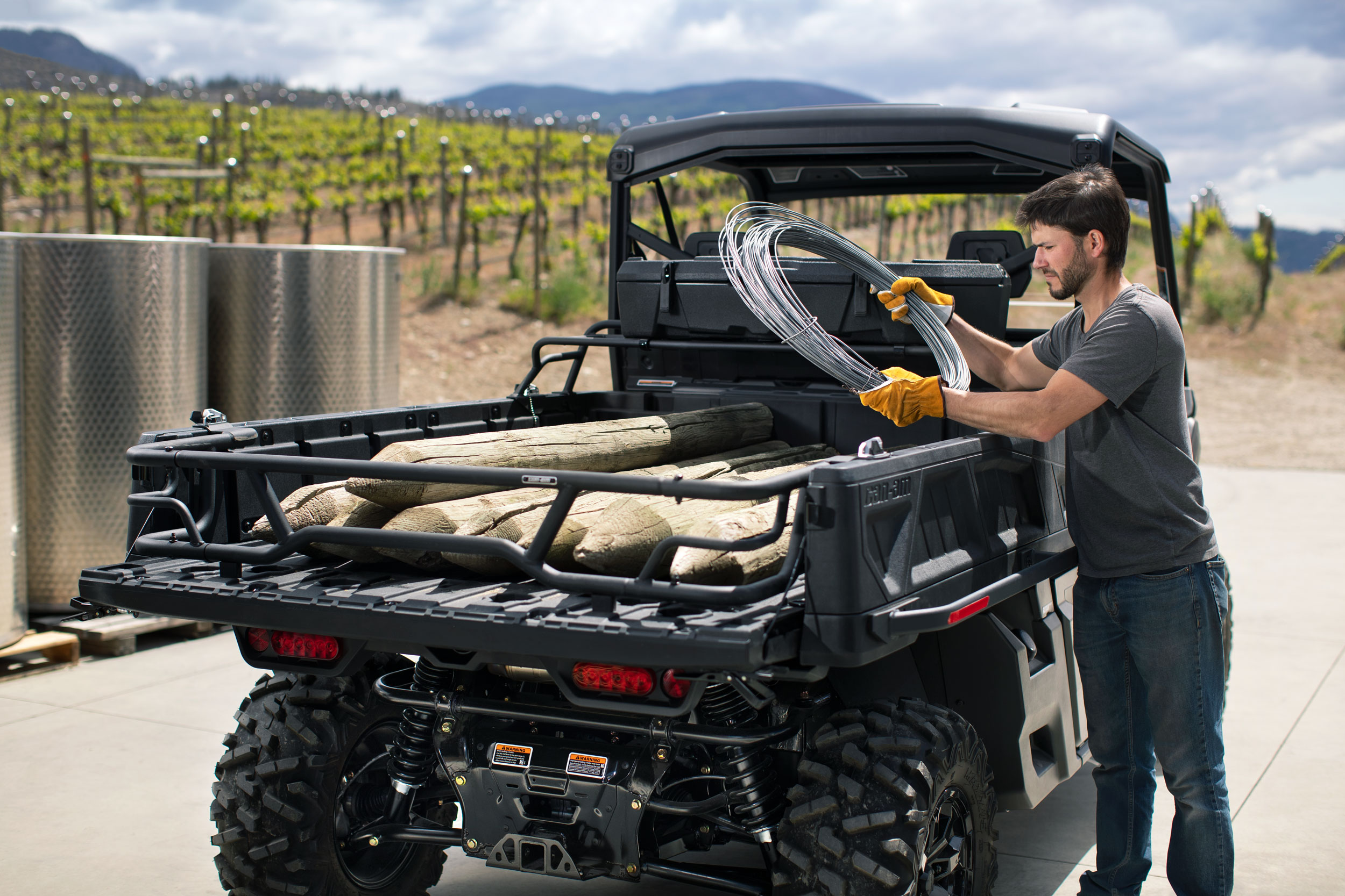 Can-Am Defender by workers in a vineyard