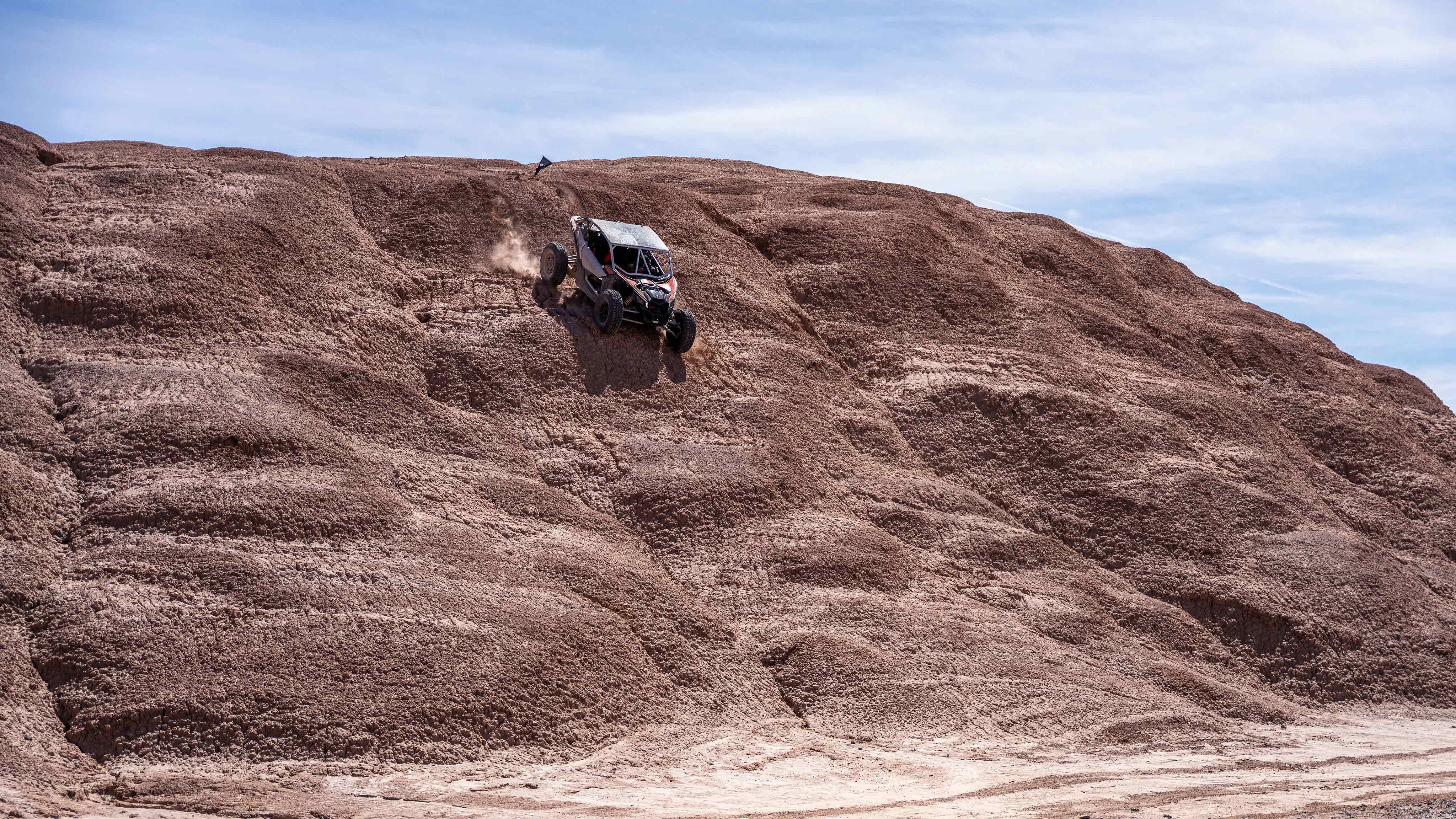 Un vehículo Can-Am Off-Road sobre una colina en el desierto  