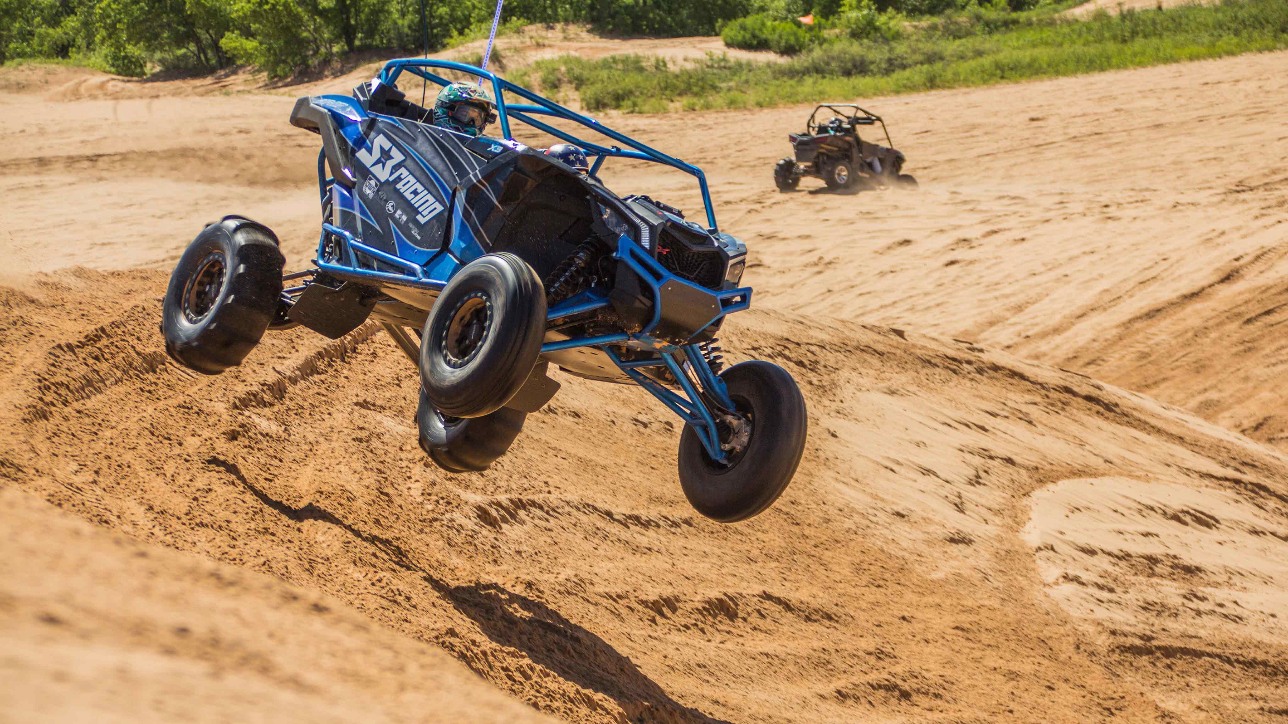 Can-Am Off-Road vehicle jumping dune