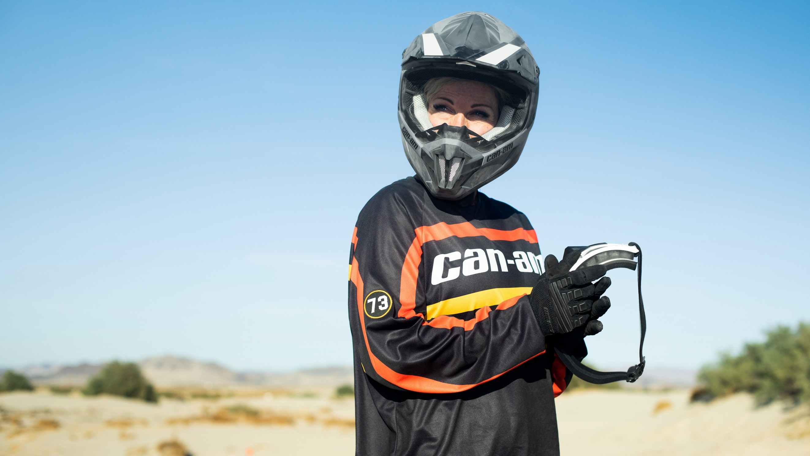 Woman prepping her next Off-Road ride with Can-Am Gear