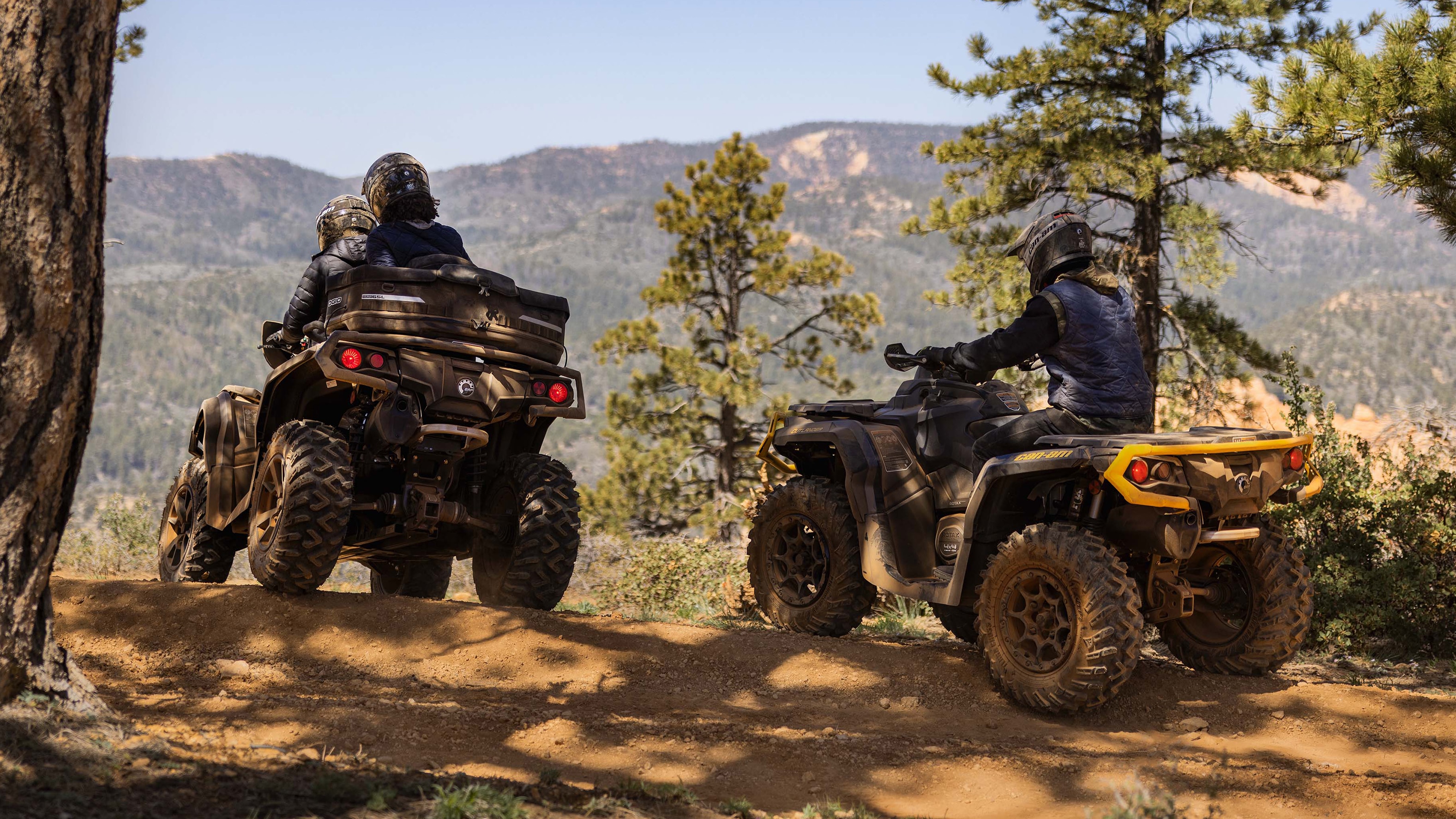 Riders driving an ATV Can-Am vehicle.