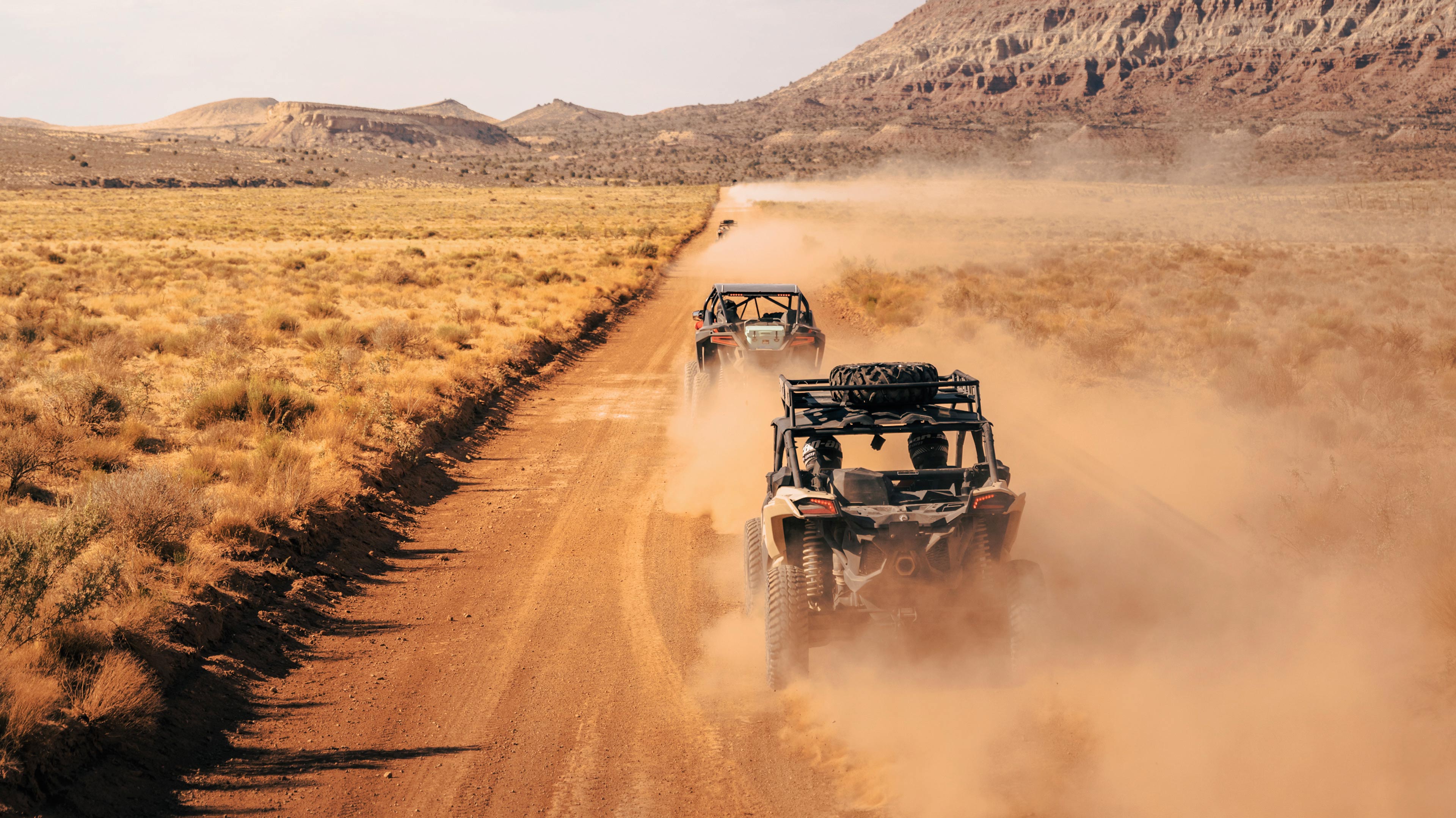 Can-Am rides kicking up dust on a trail