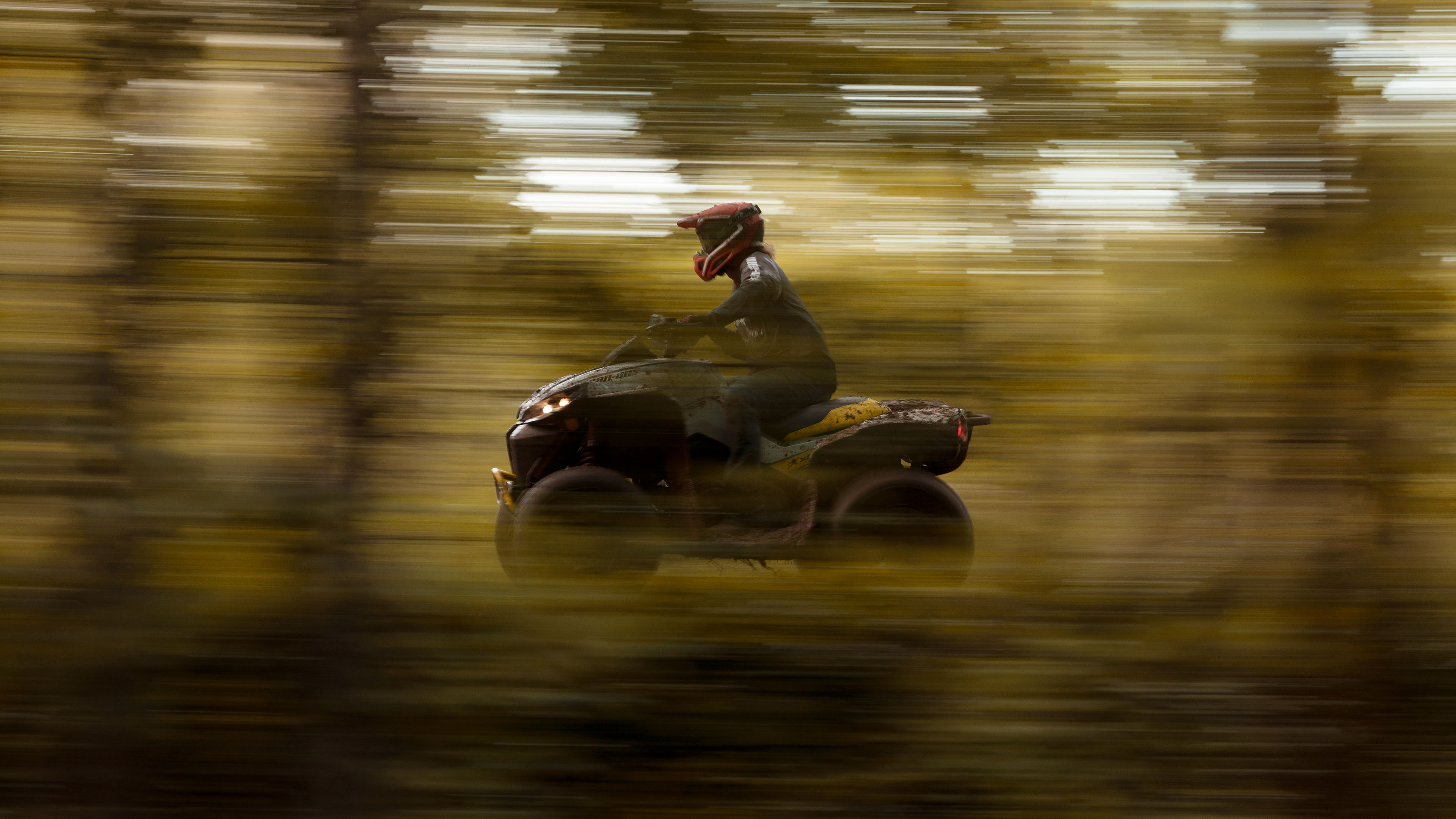 A Can-Am Renegade with blurred surroundings