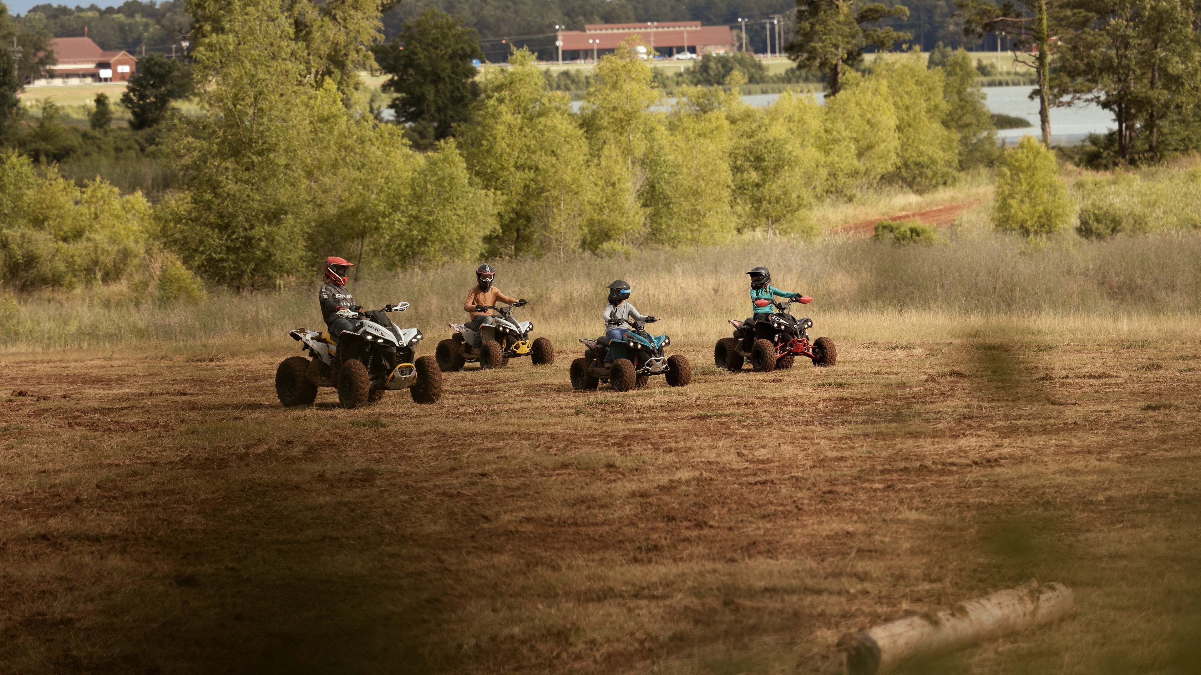 Four Can-Am ATVs through the trees