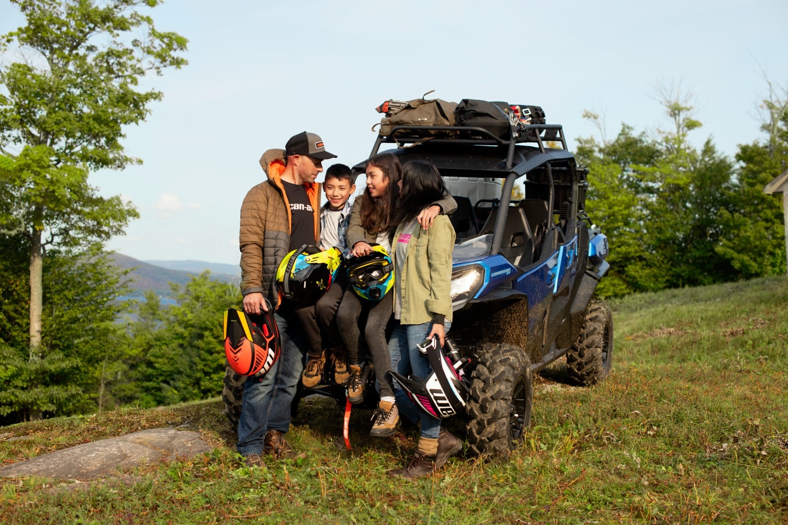 A family of four in front of their Can-Am Commander MAX XT on an adventure