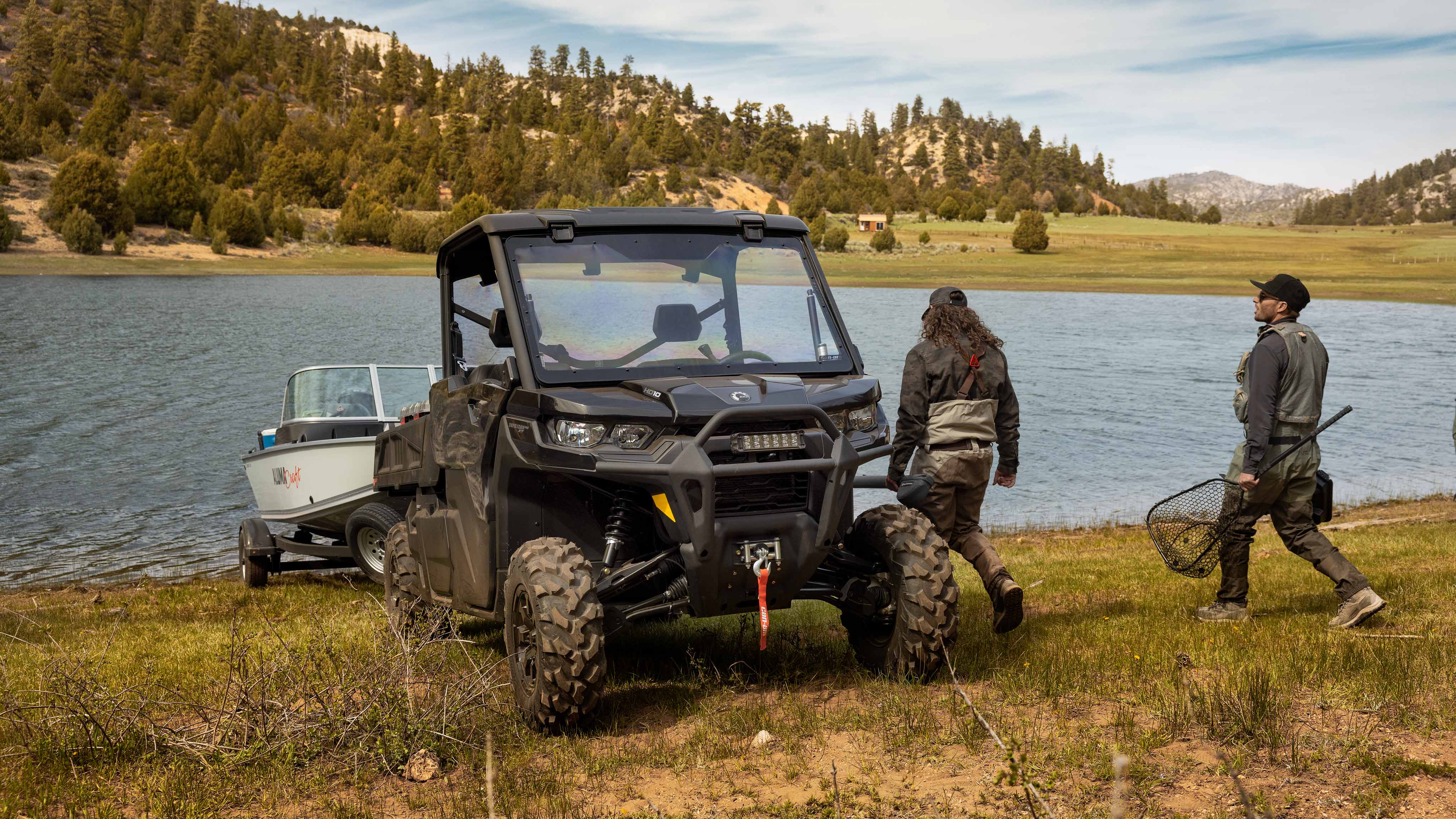 Deux hommes près d’un lac avec un Can-Am Traxter Pro 