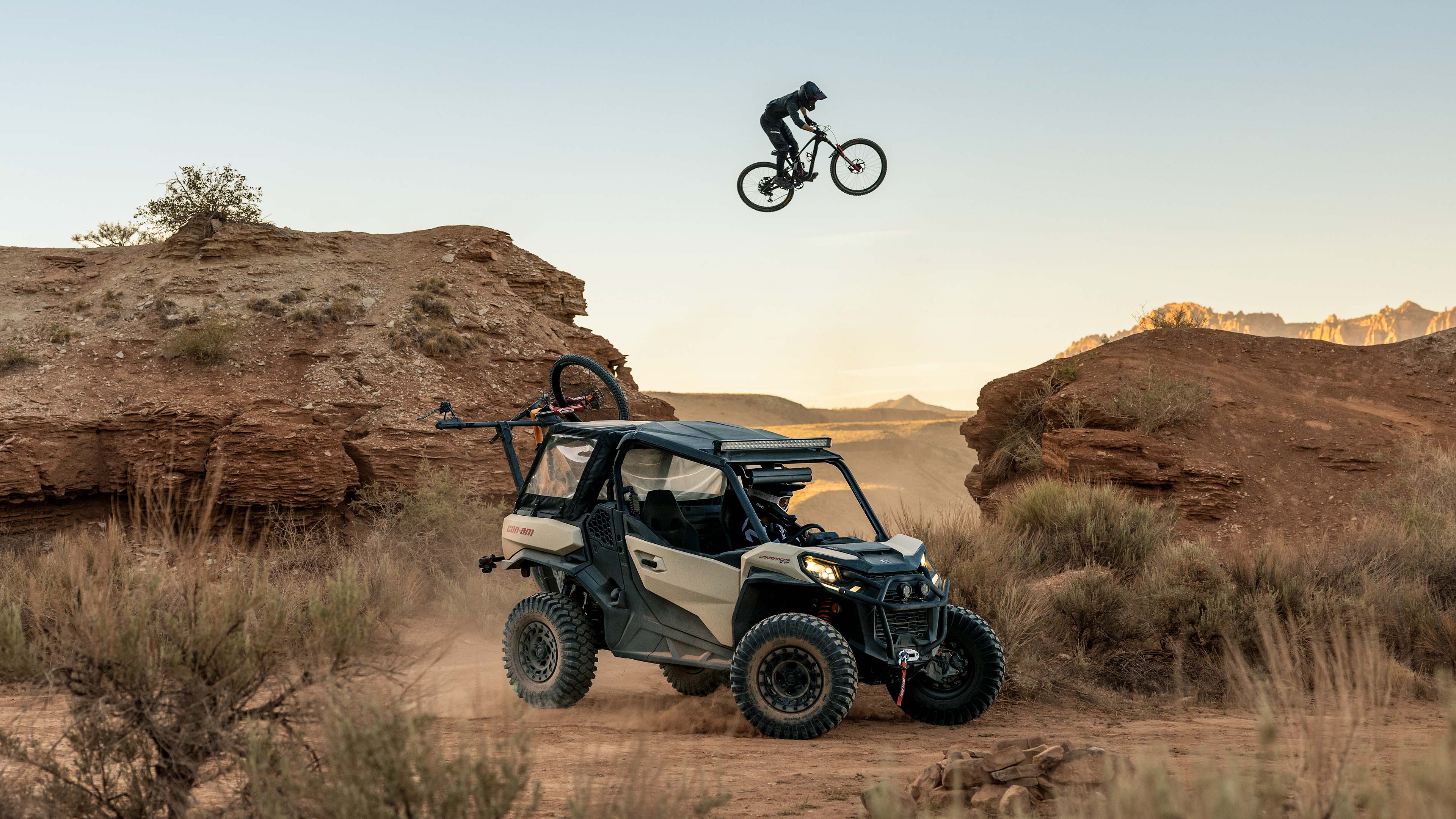 Cyclist jumping over Can-Am side-by-side vehicle