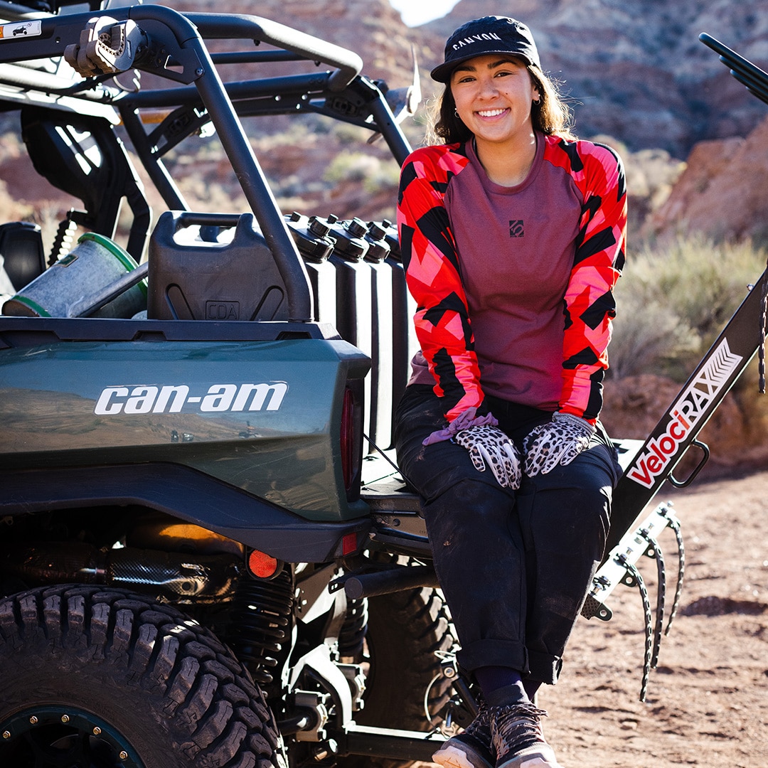 Samantha Soriano sitting down at the back of a Can-Am Commander and looking into the camera for a photo