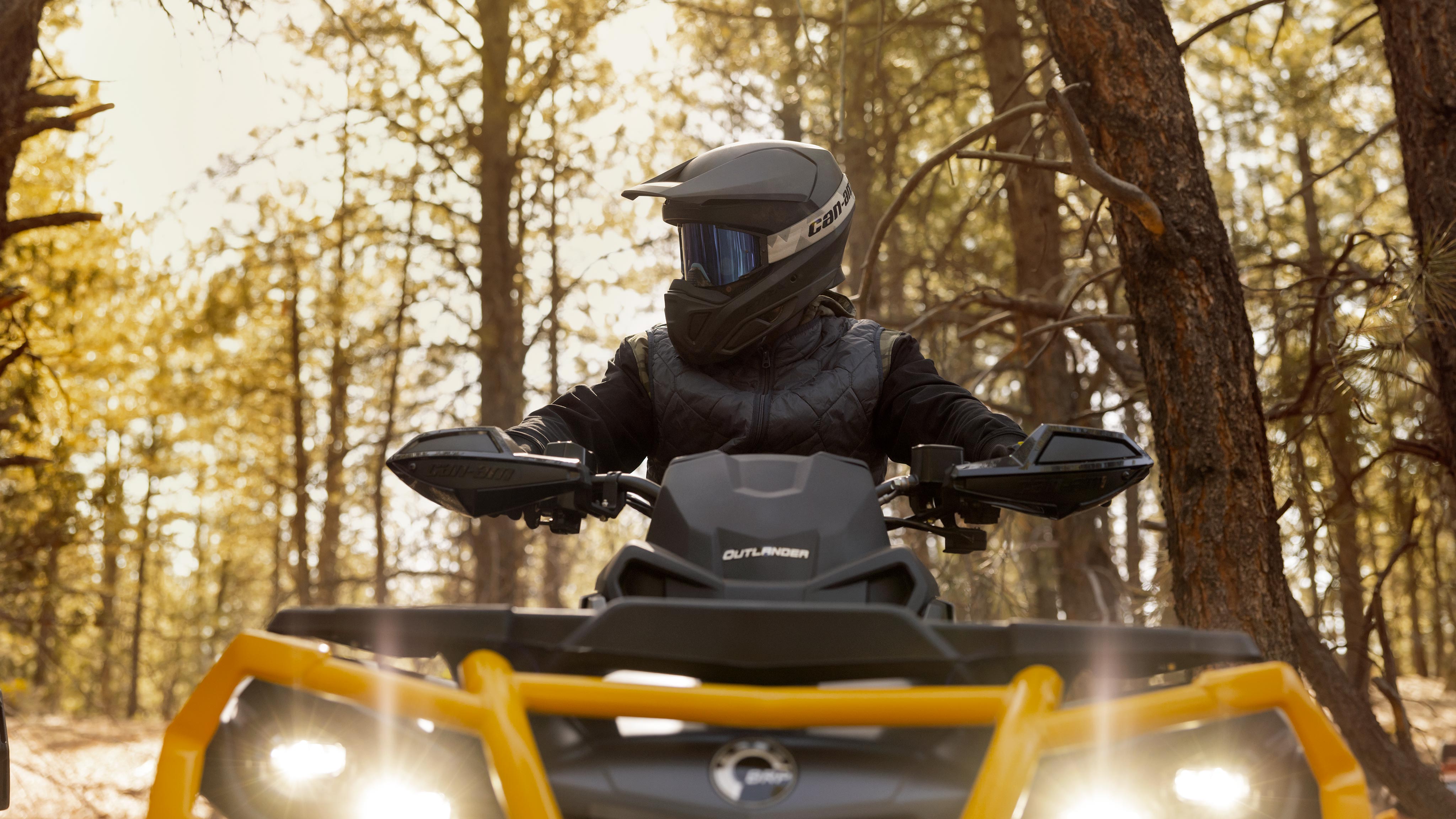 Driving a Can-Am Outlander ATV in a forest 