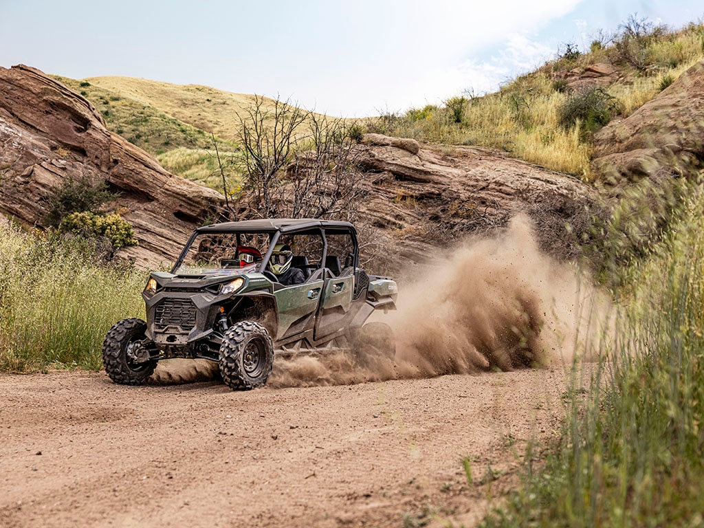A Can-Am Commander SxS driving on a dirt road