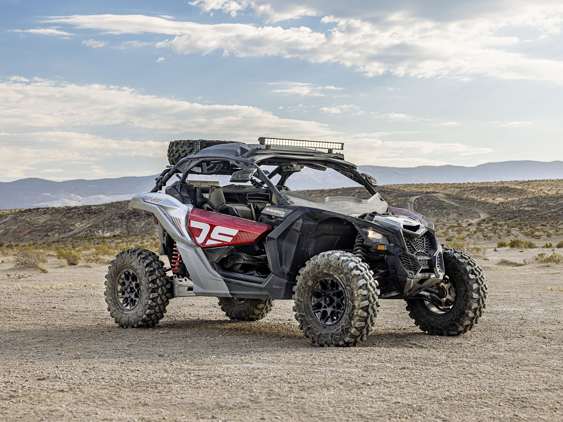 2024 Can-Am Maverick X3 parked in the middle of a dirt field