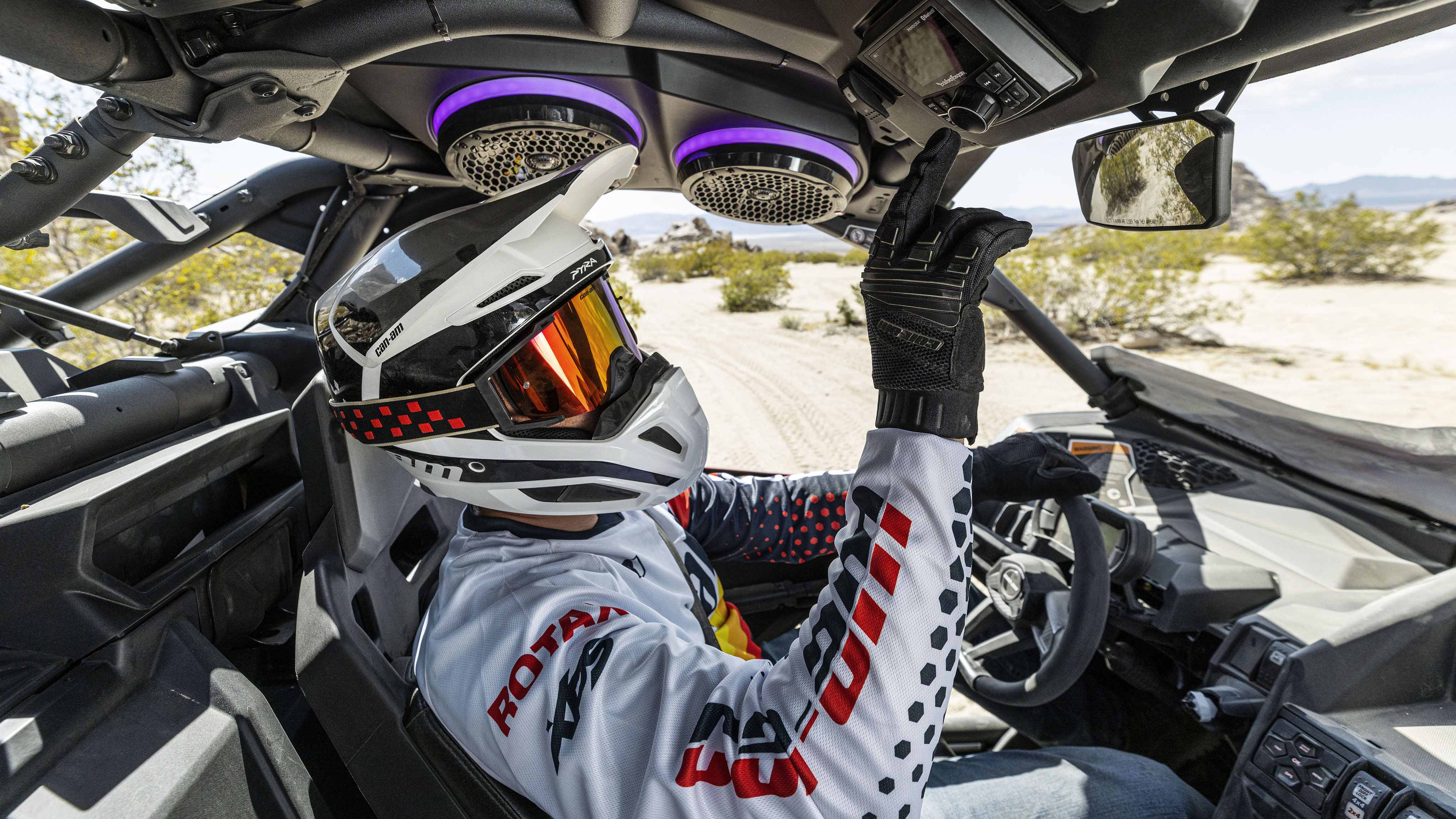 Rider using the sound system in his 2024 Can-Am Maverick X3 SxS