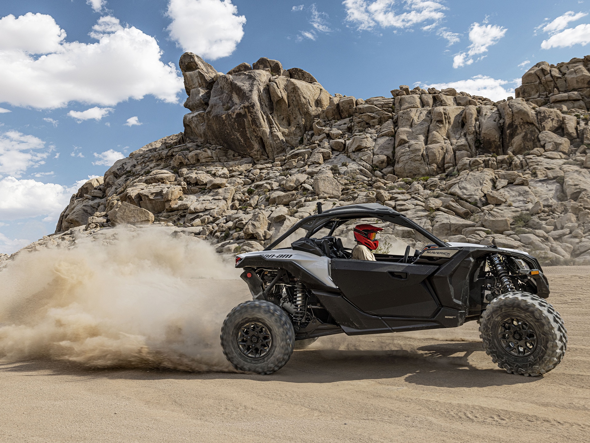 2024 Can-Am Maverick X3 side-by-side vehicle riding in the dirt