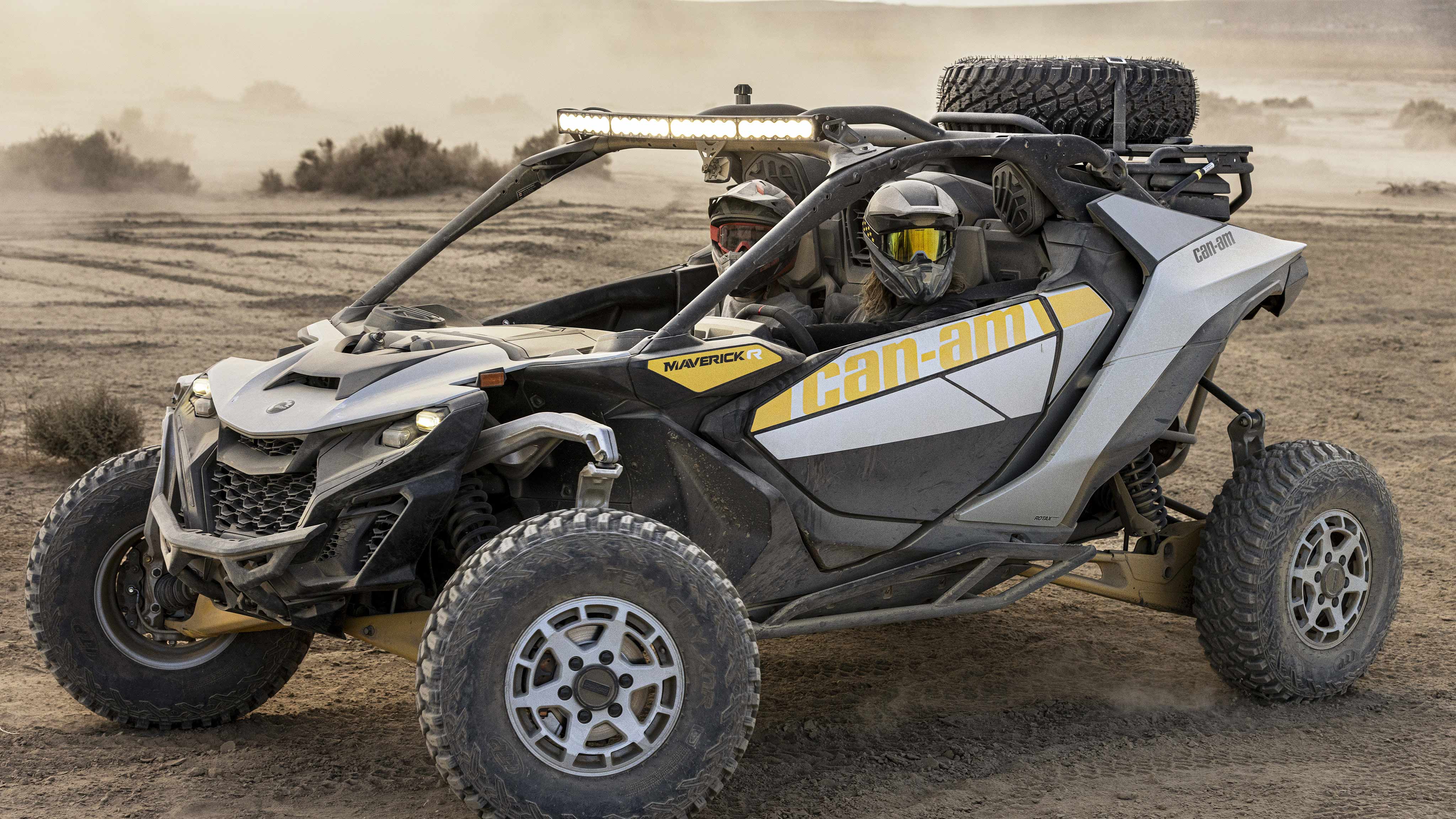 Two riders sitting in a Can-Am Maverick R SxS