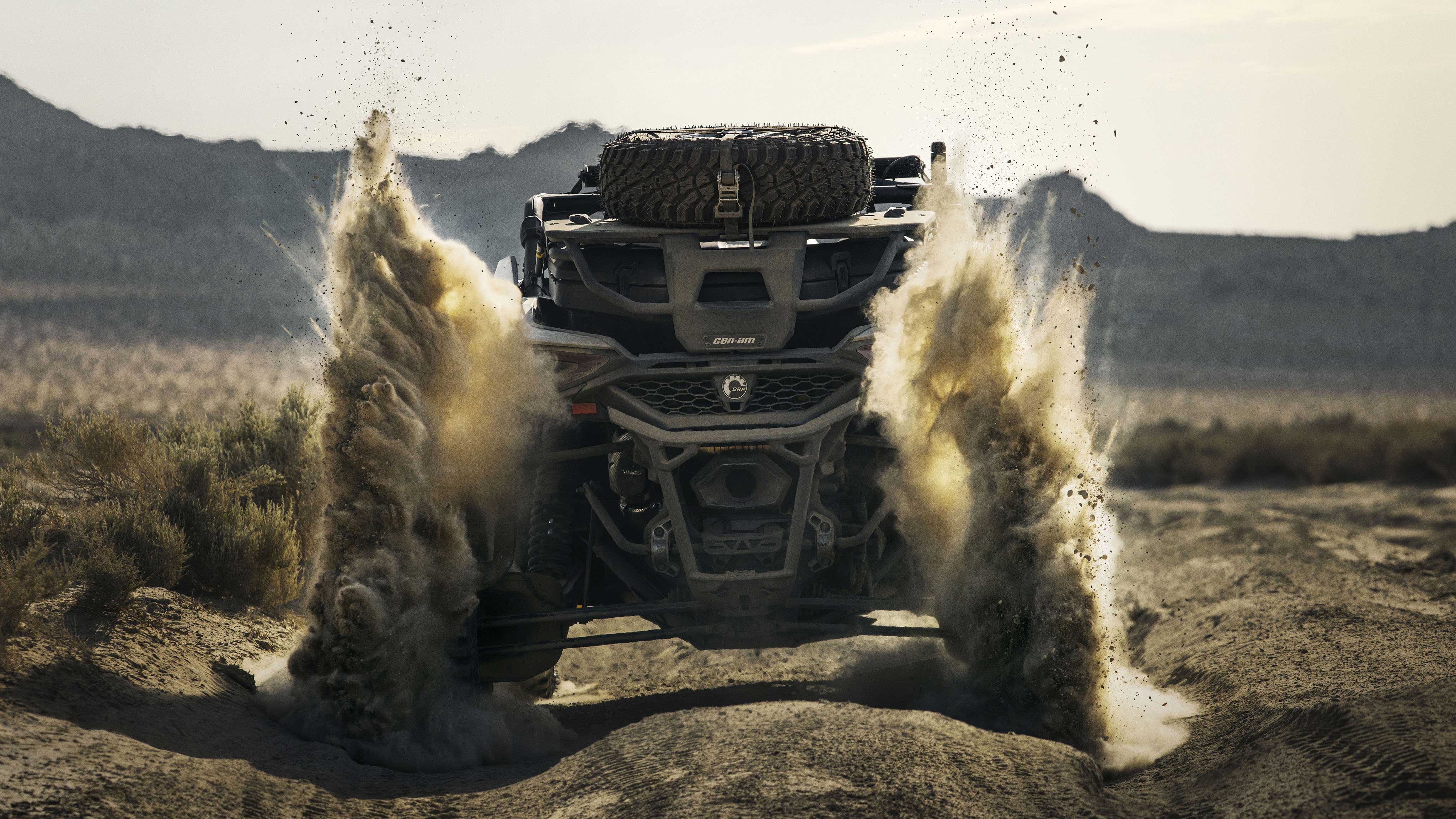 A Can-Am Maverick R revving up dust in the desert