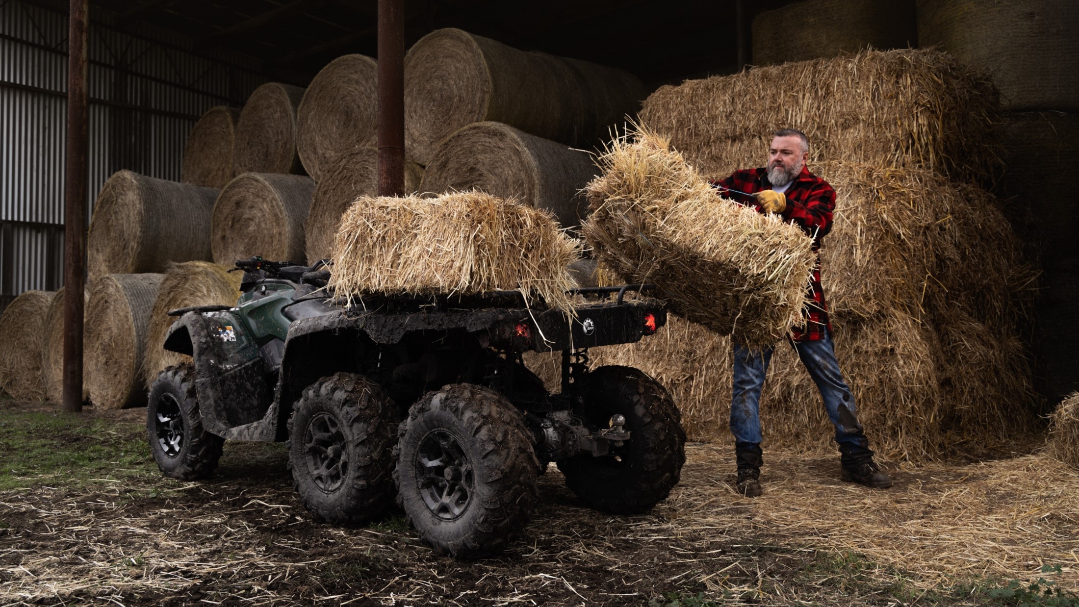 Farmer loading hay onto a Can-Am Outlander 6x6