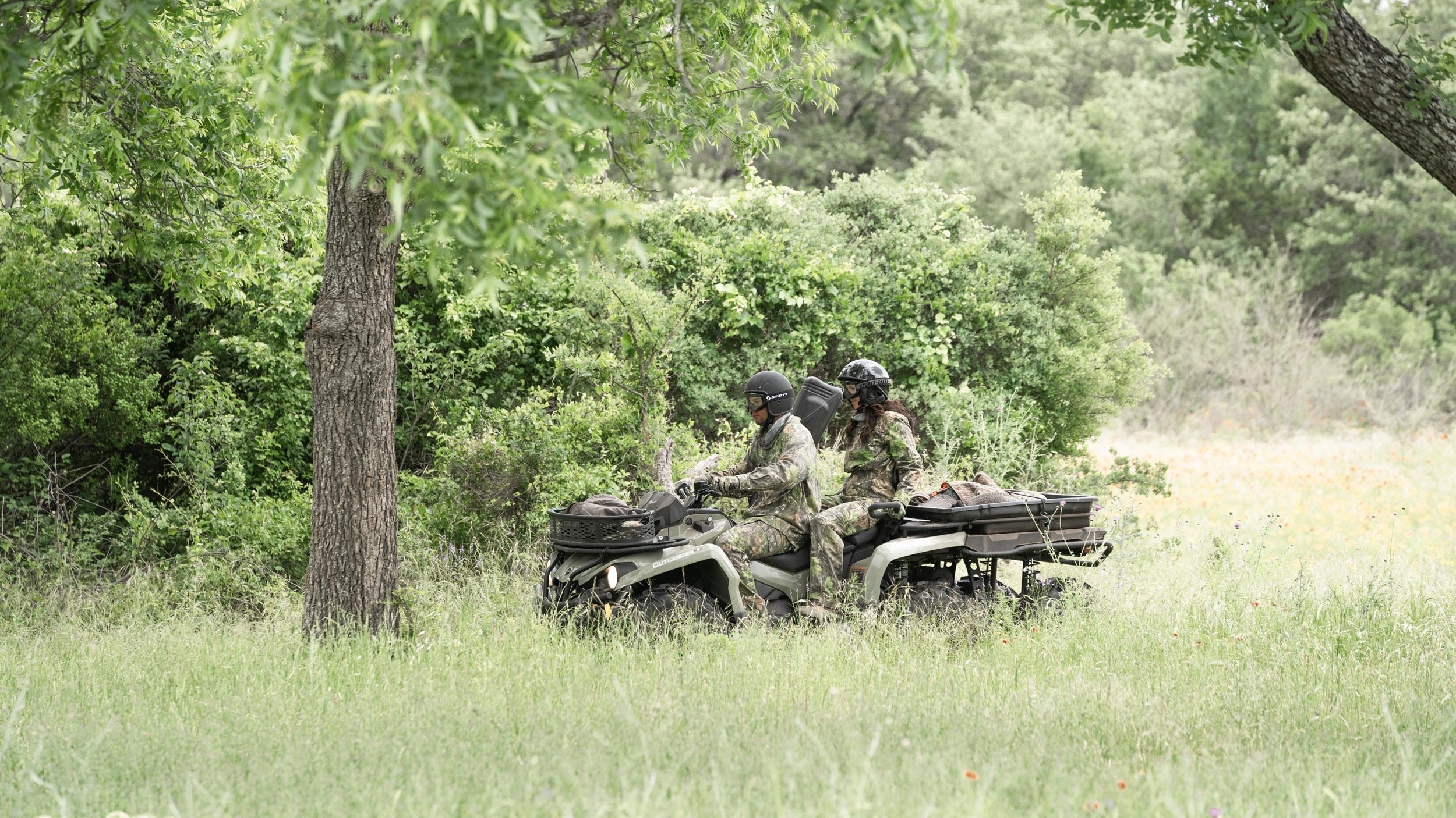 Two hunters riding a 2-seater Can-Am Outlander MAX 6x6 DPS ATV