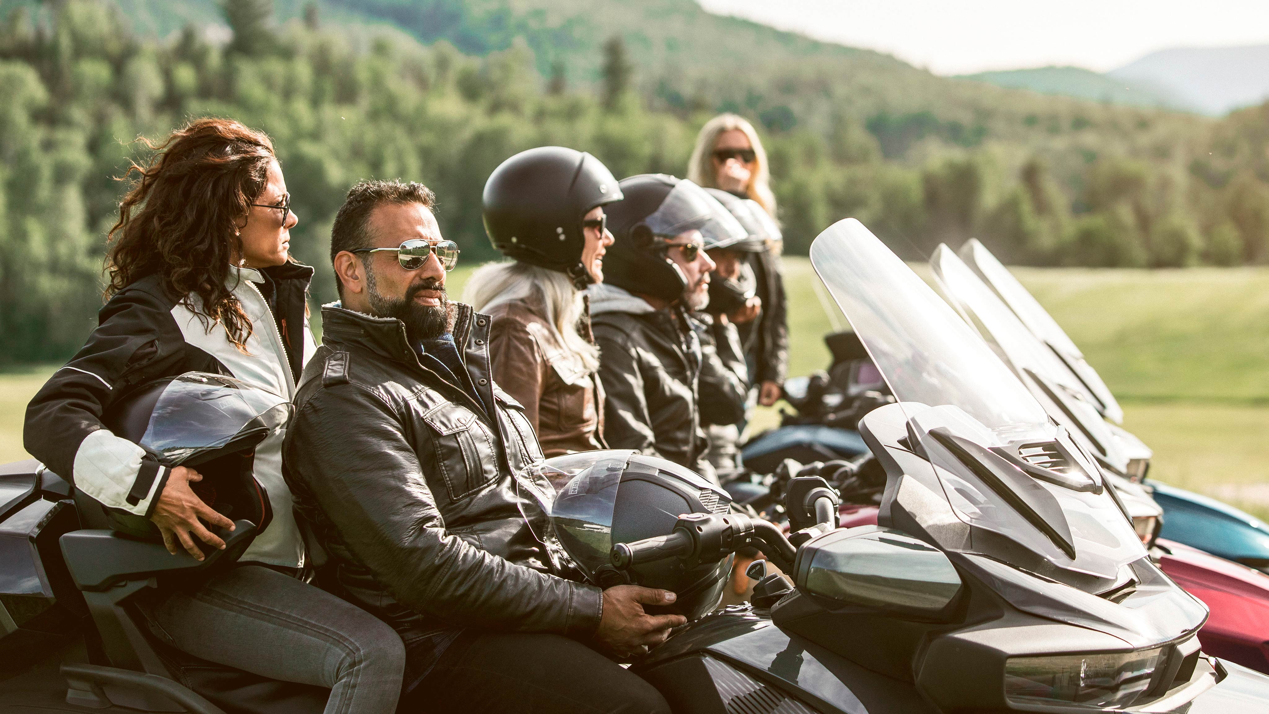 Group of friends on Can-Am Spyder RT in a meadow
