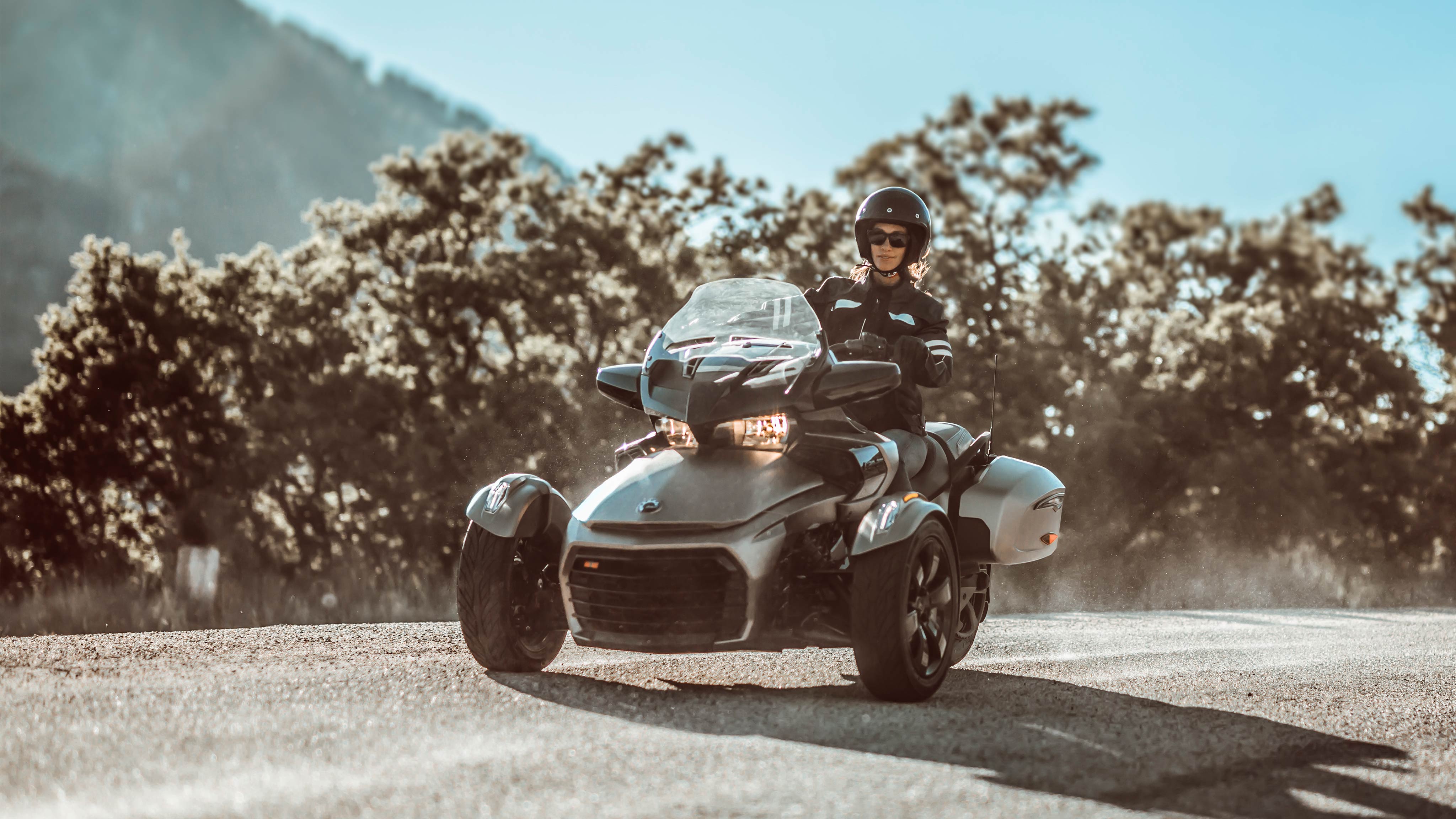 Women riding on a Can-Am On-Road Spyder vehicle