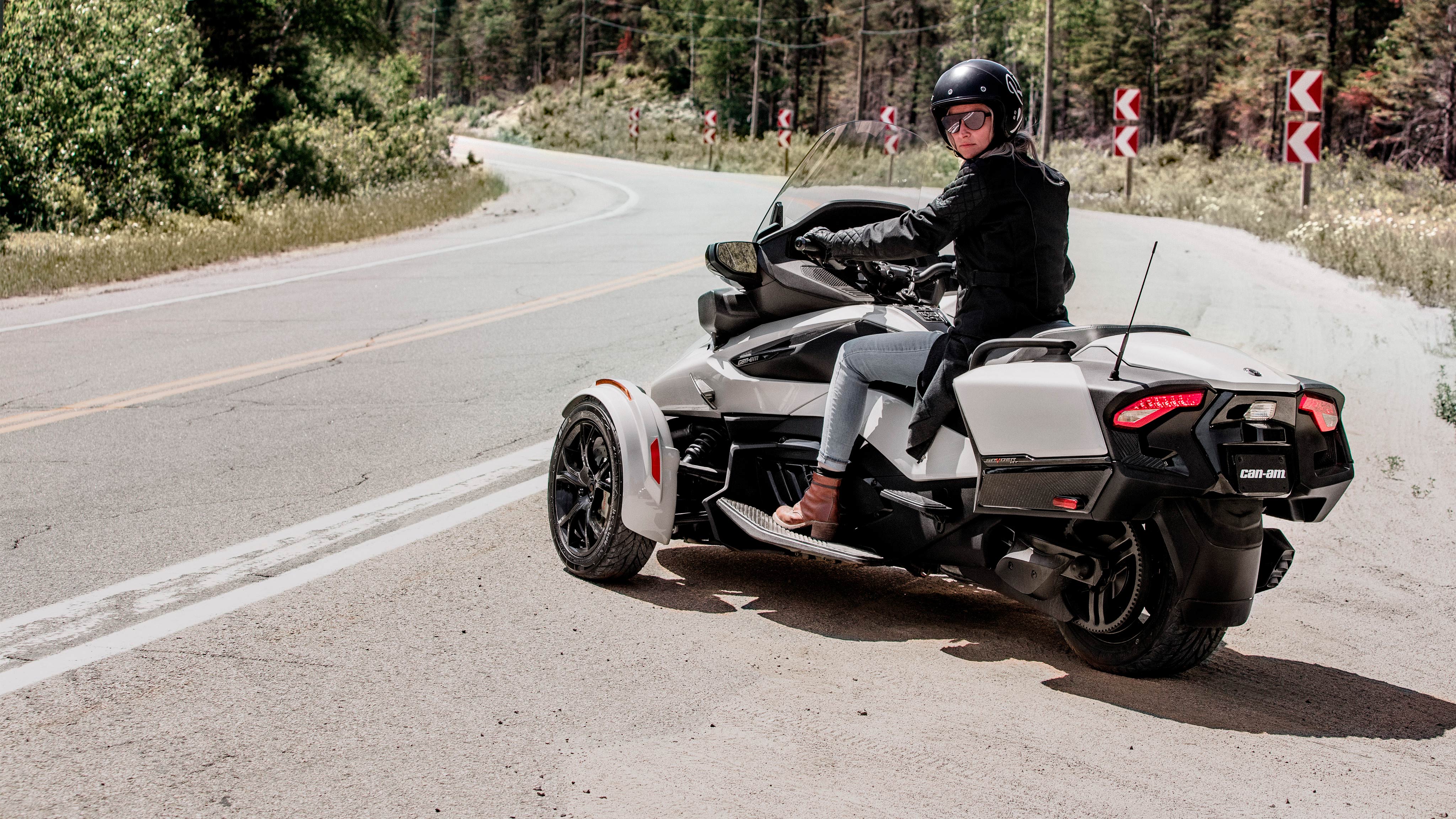 Woman riding Can-Am Spyder RT pearl white vehicle	