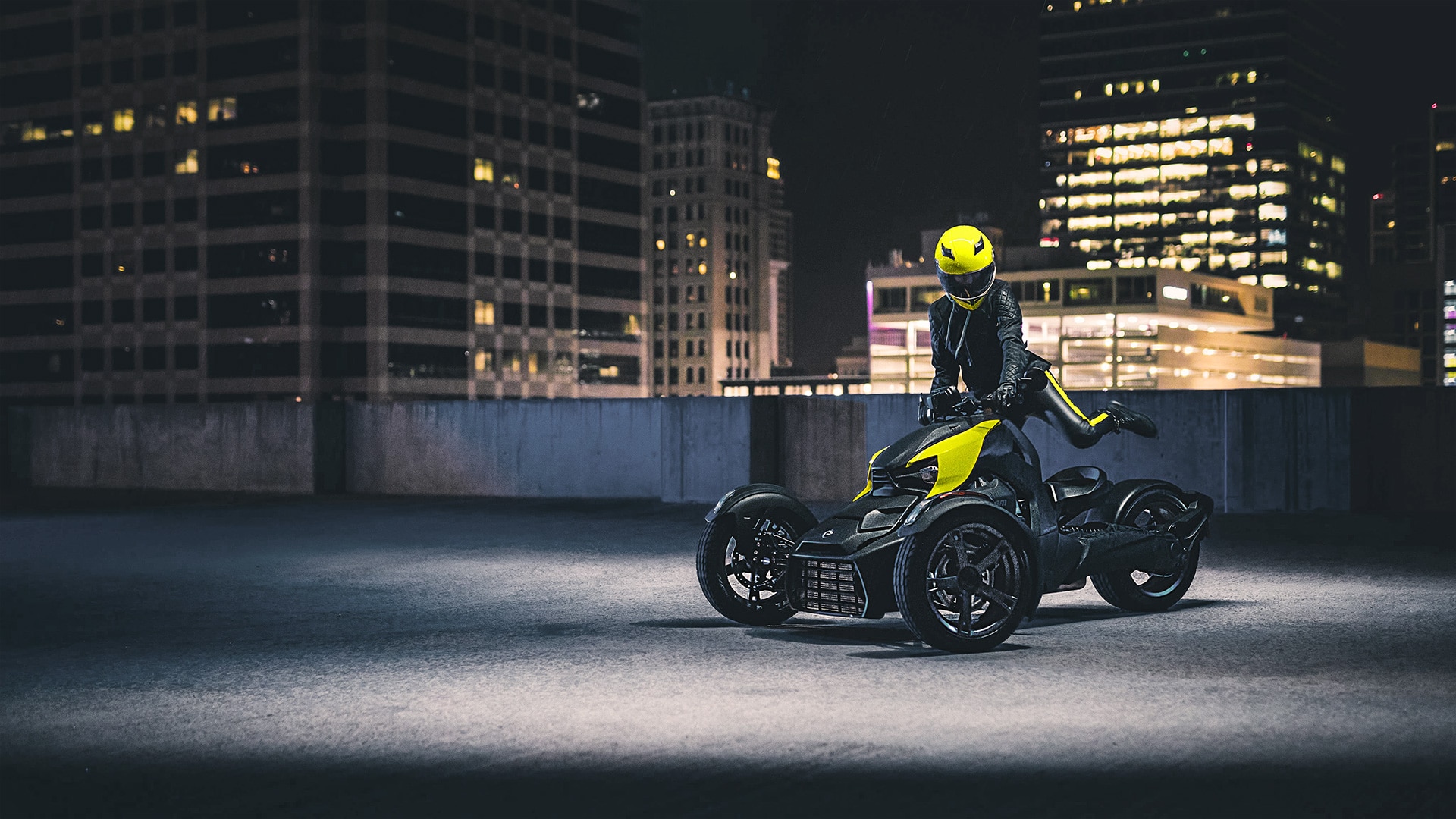 Woman riding her Can-Am Ryker in the city during night