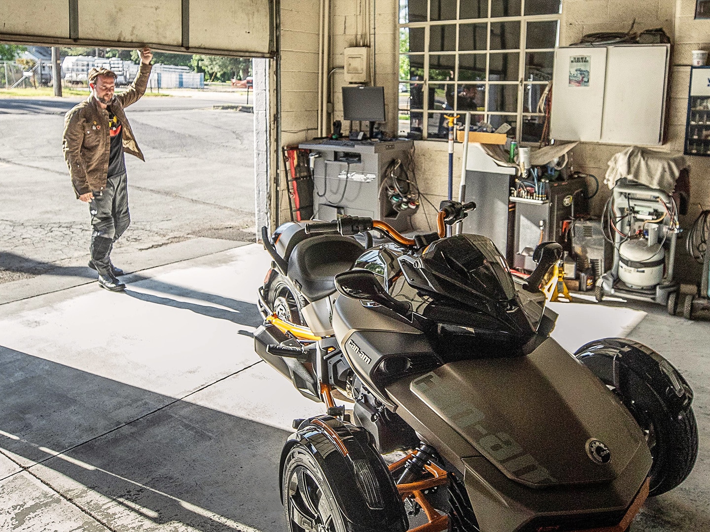 Man storing his Can-Am Spyder in his garage 