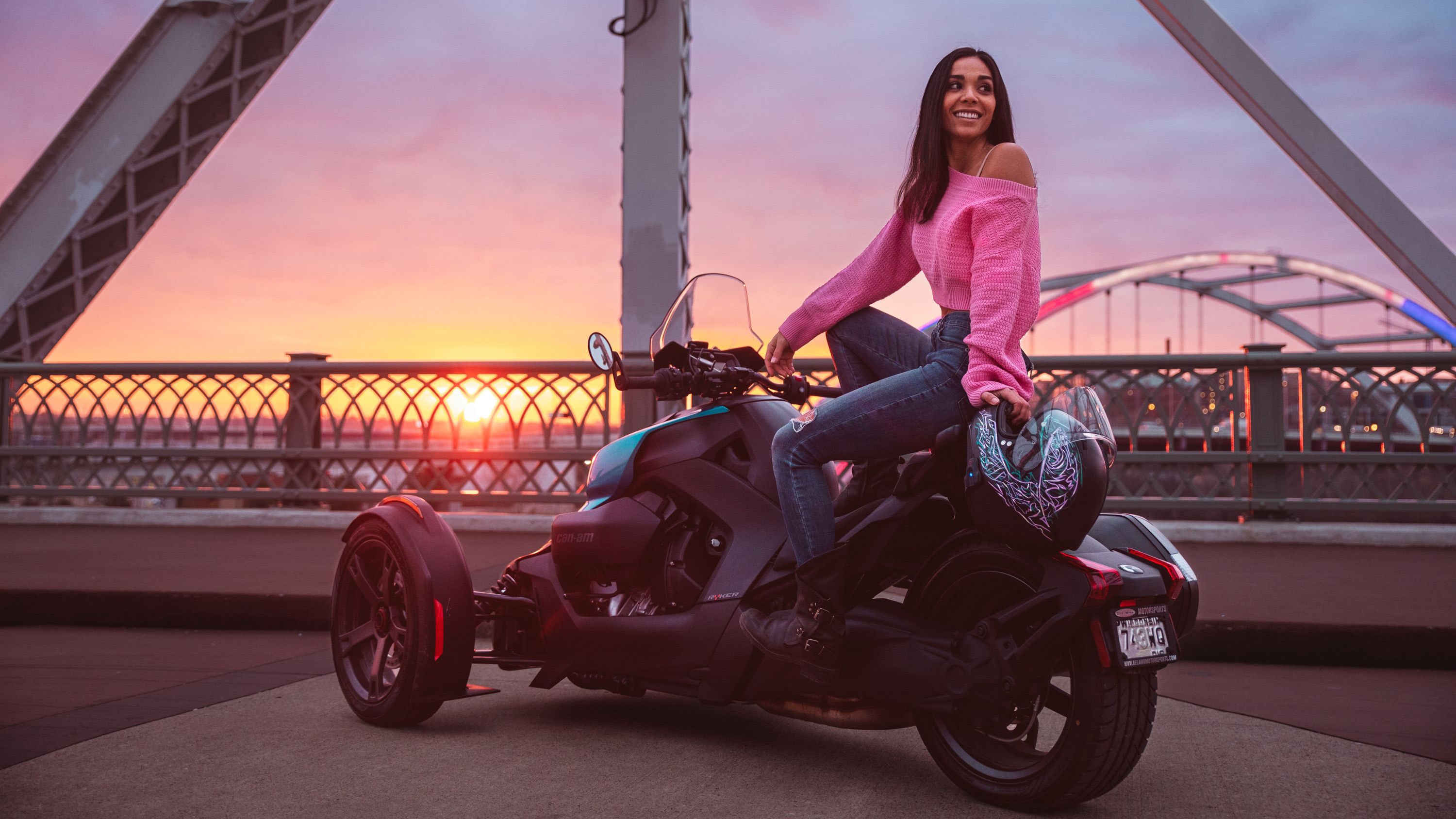 A woman on her vehicle at sunset