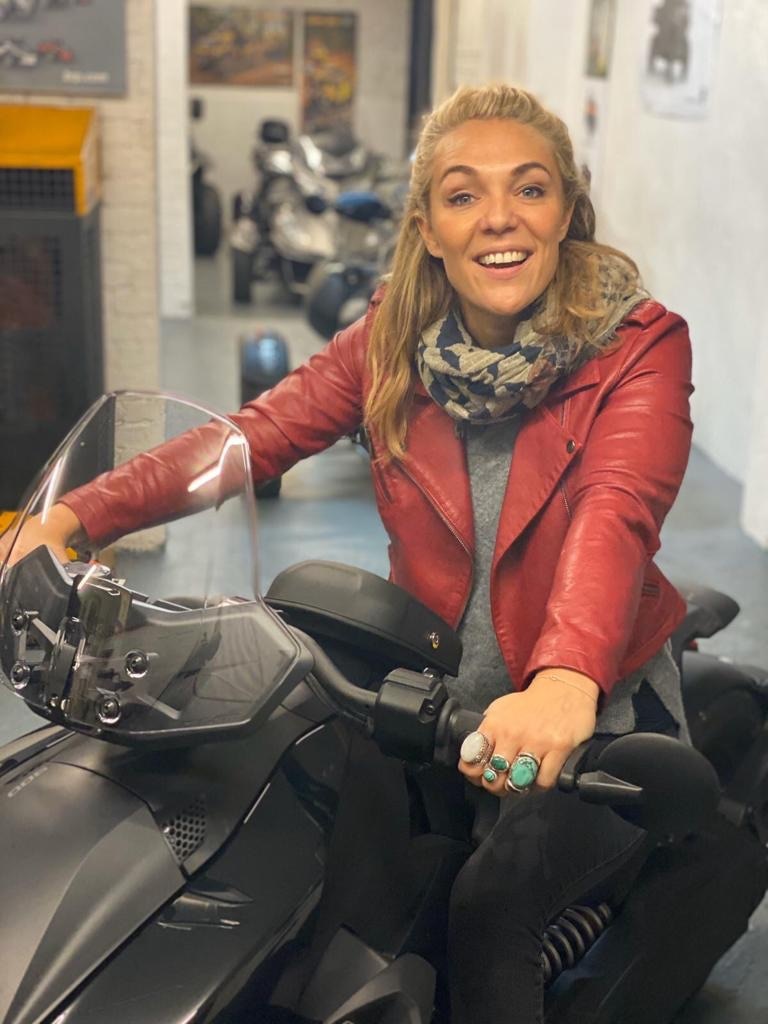Women Community rider Sophie Morgan sitting on a Can-Am 3-wheel motorcycle