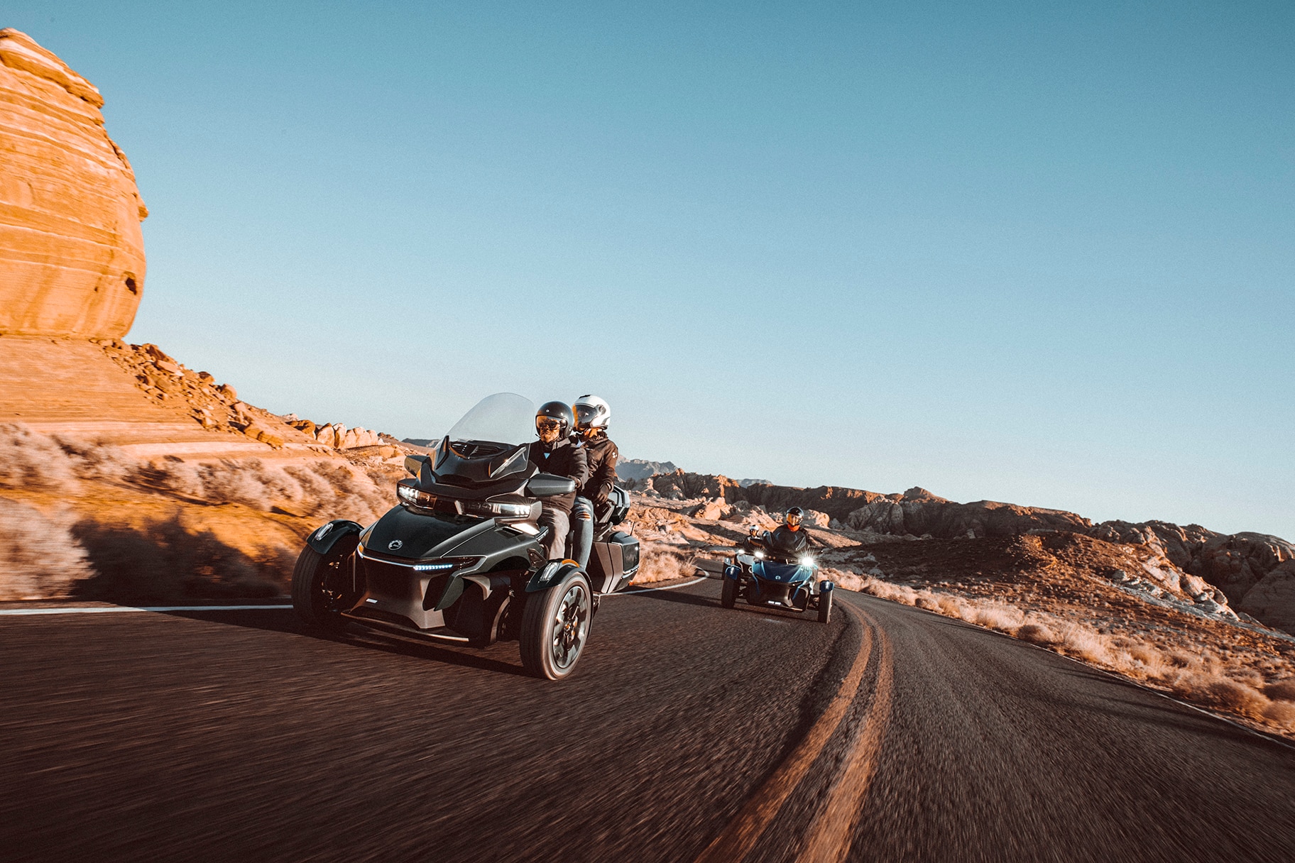 People on Can-Am Spyders on the road