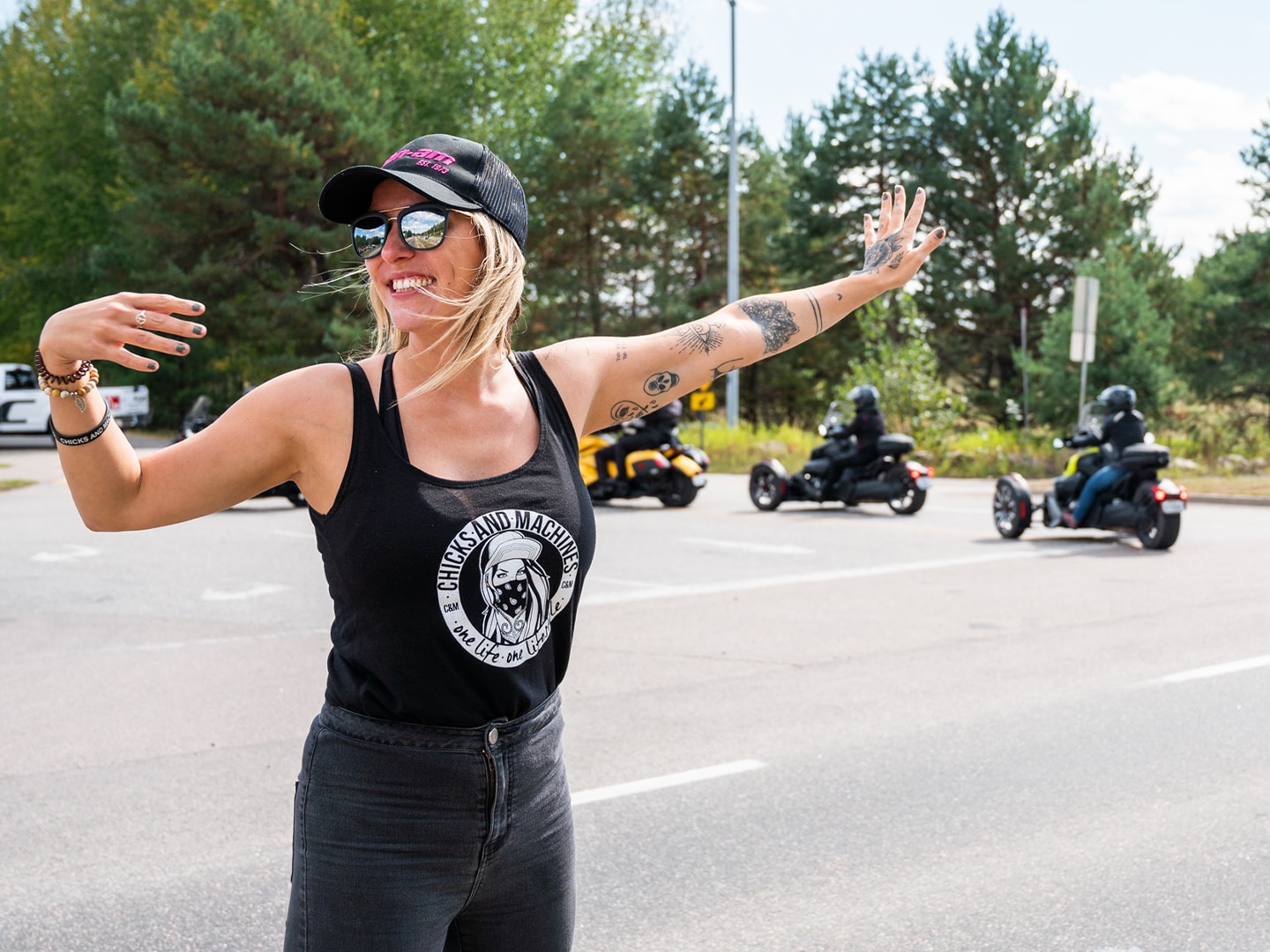 A woman giving 3-wheel riders directions