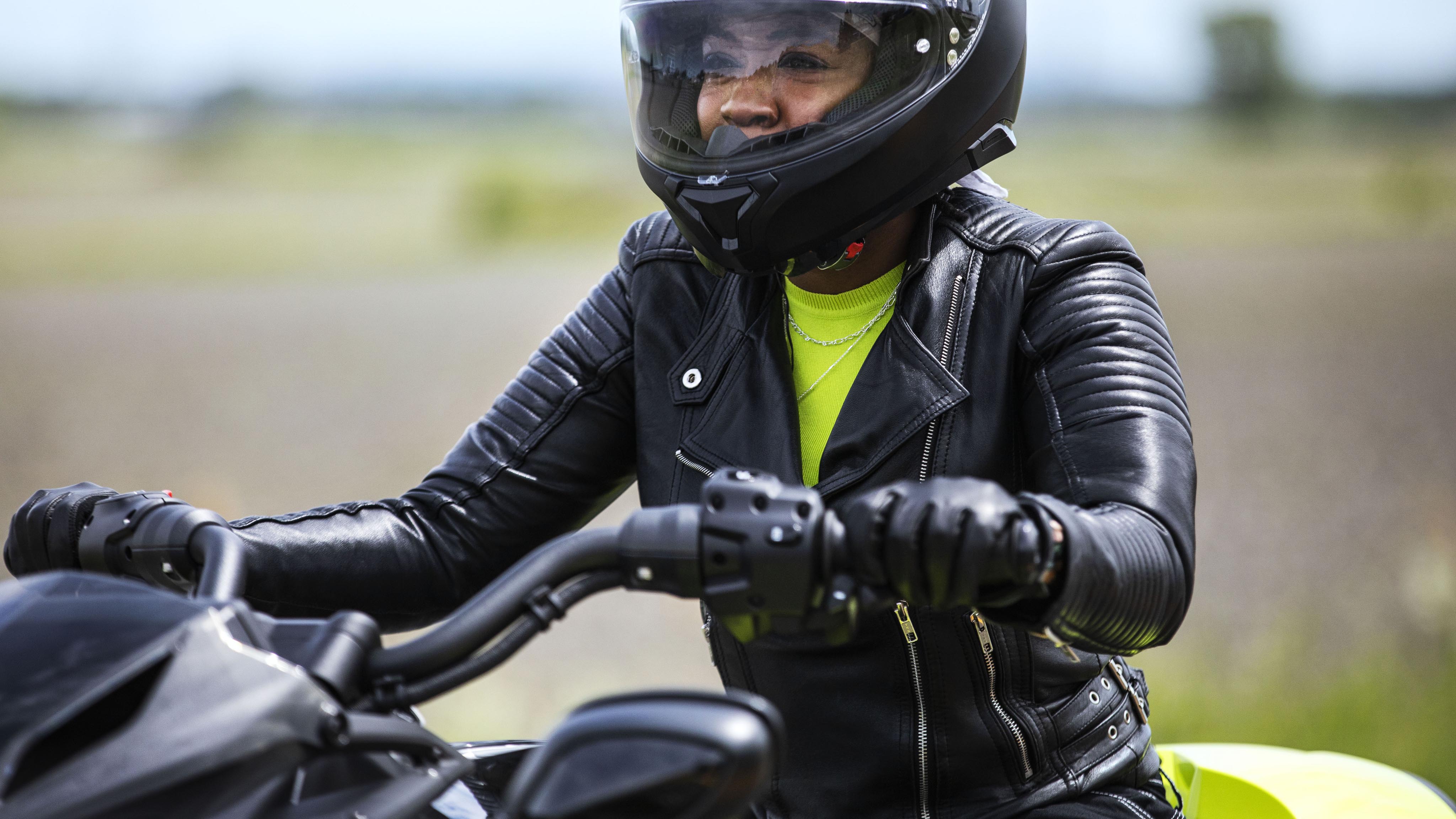 Woman with riding gear on her Can-Am Rider 