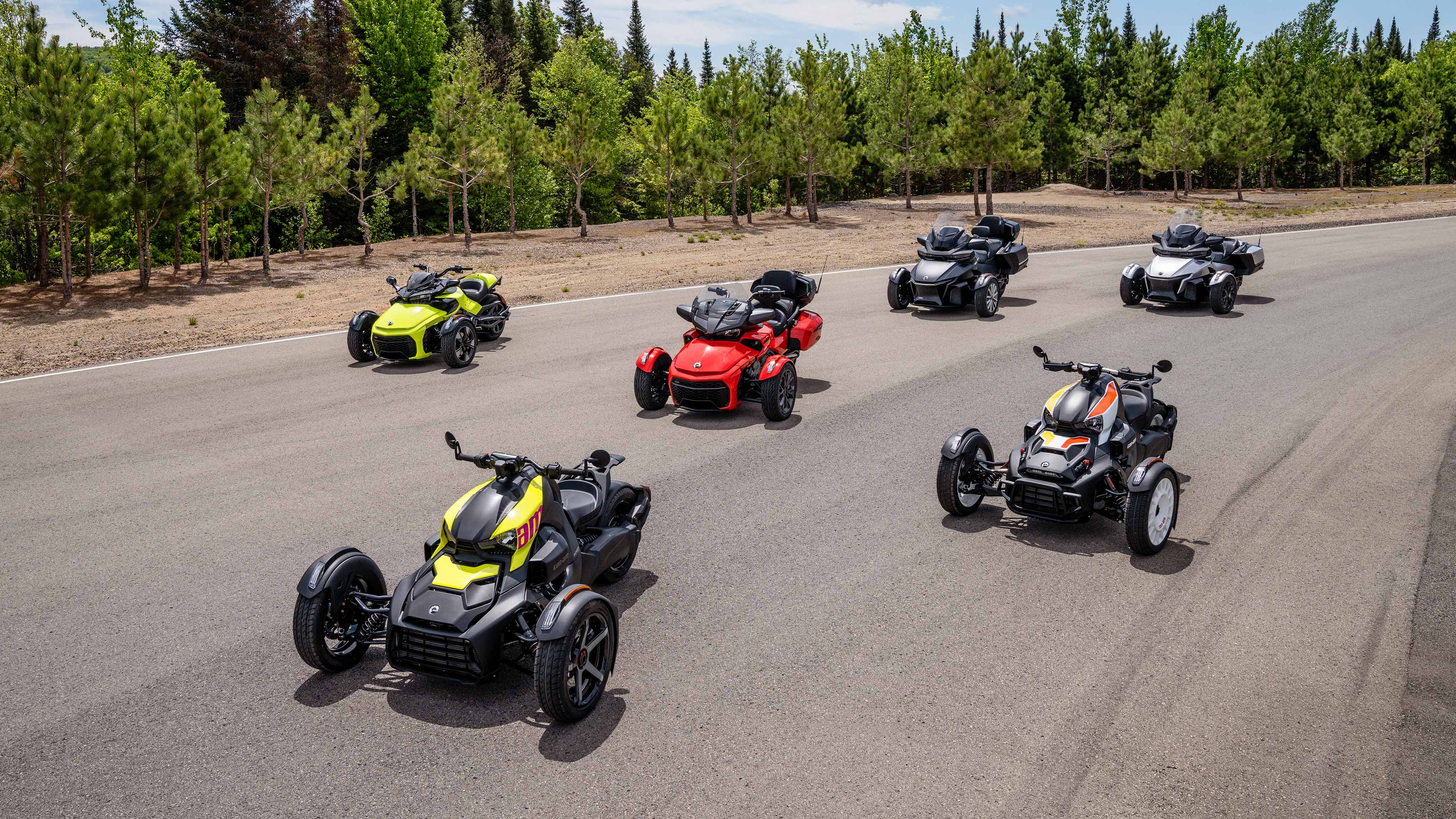 Six Can-Am vehicles parked on a road